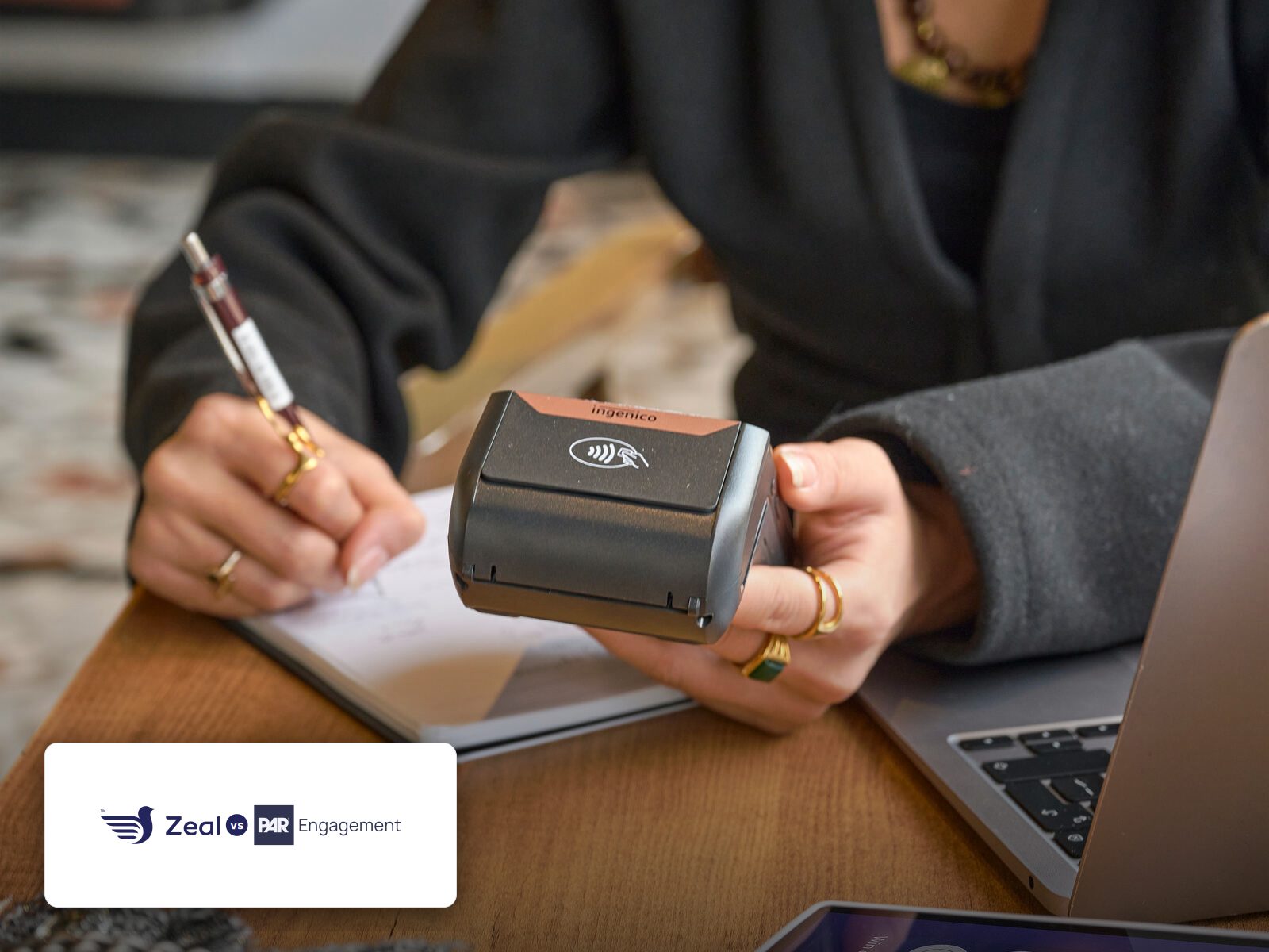 Customer tapping a phone on a Zeal-enabled card machine showing loyalty stamps