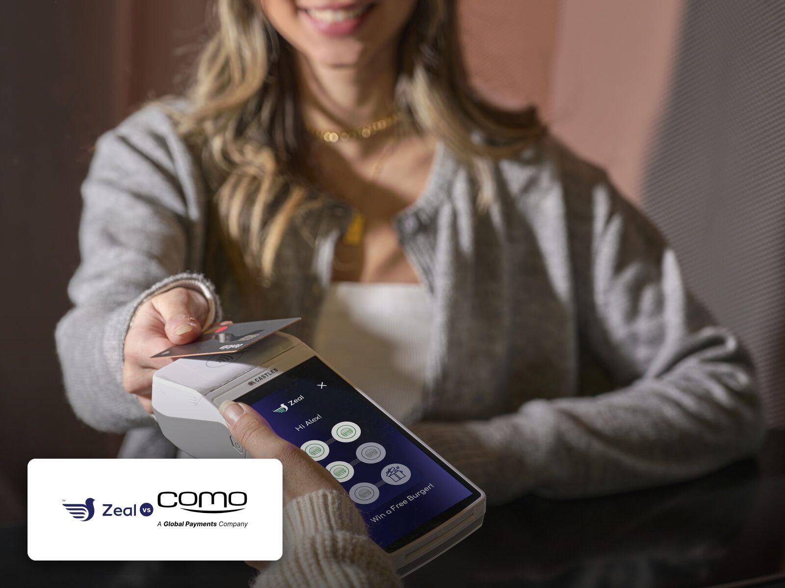 Customer tapping a phone on a Zeal-enabled card machine showing loyalty stamps