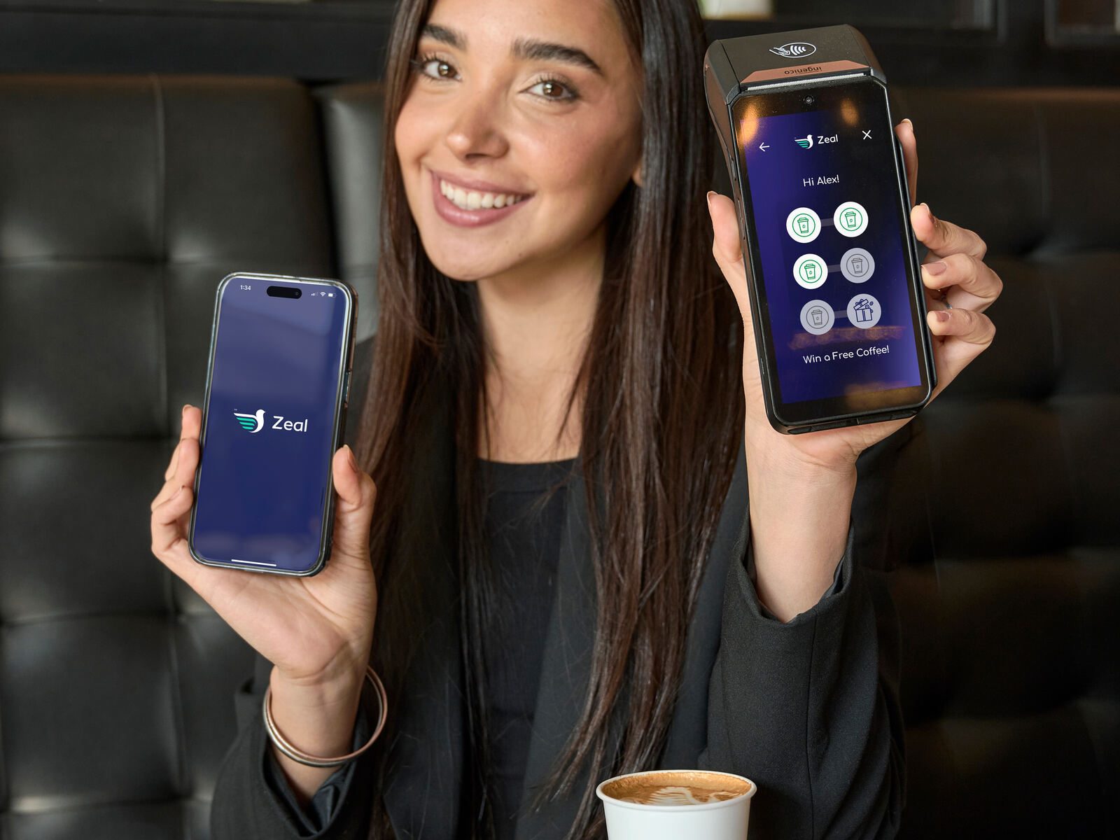 Woman holding phone showing Zeal app screen portrait cafe