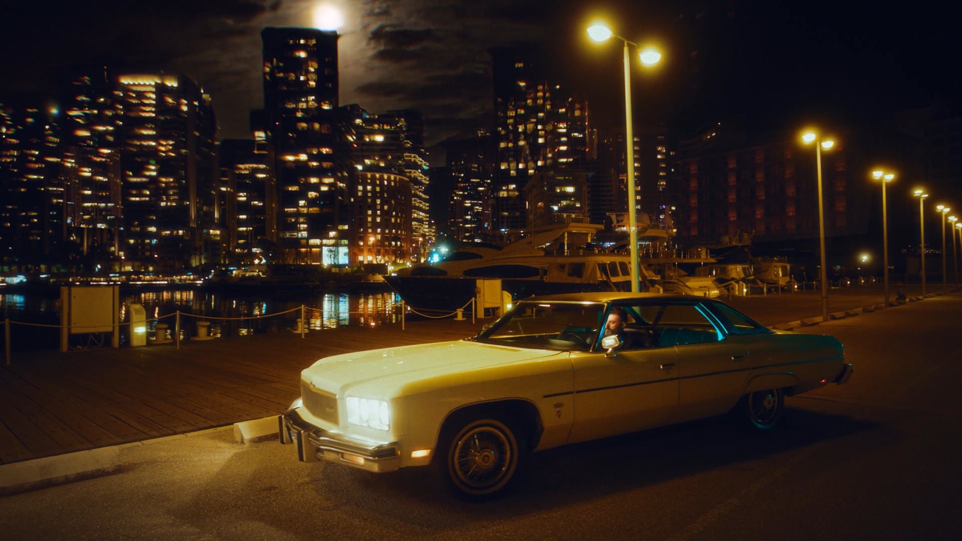 Vintage car on a night waterfront road