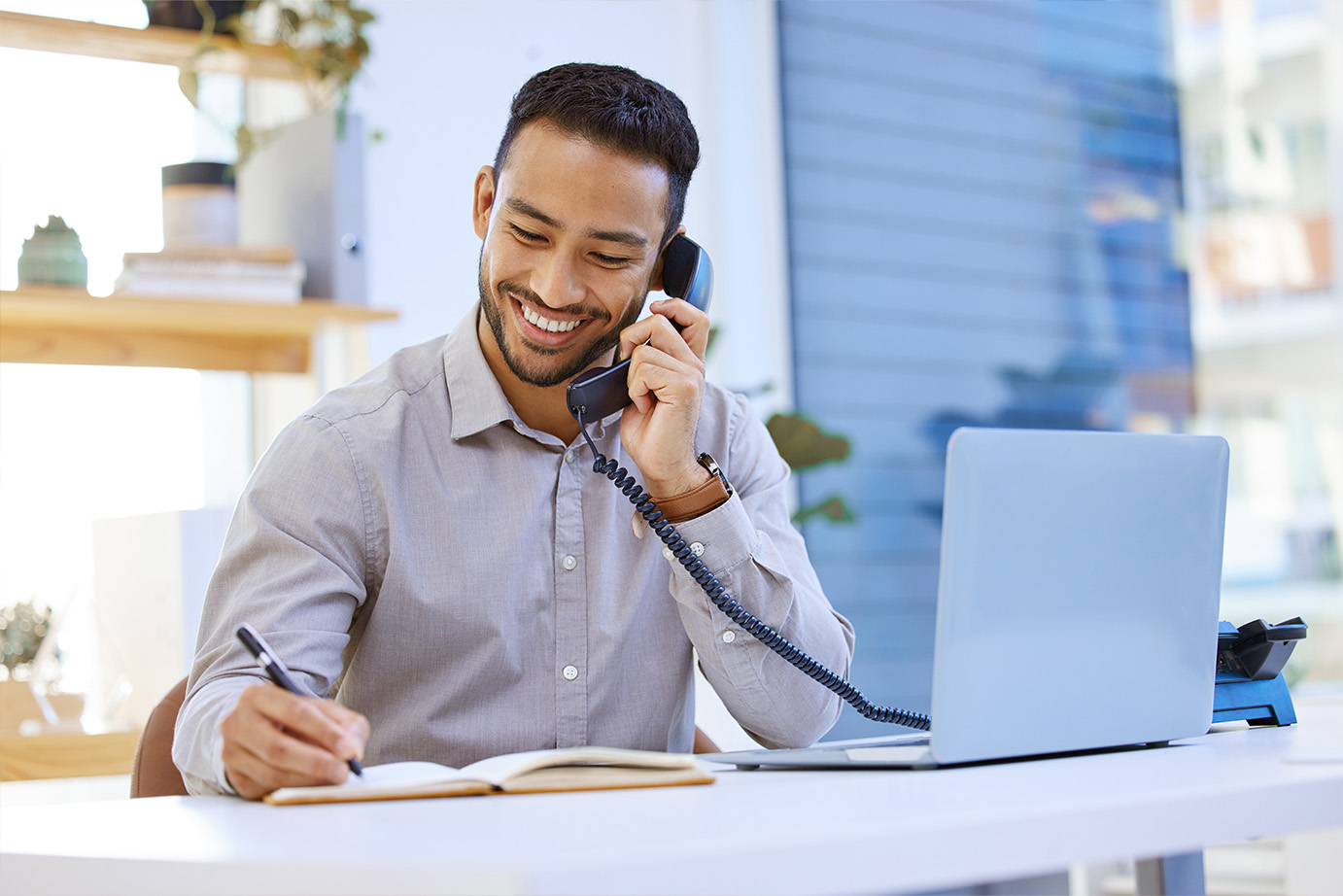 A man talking on a telephone.