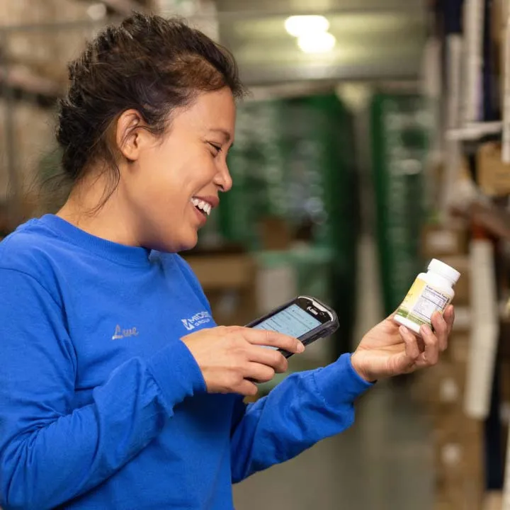woman tracking products in warehouse