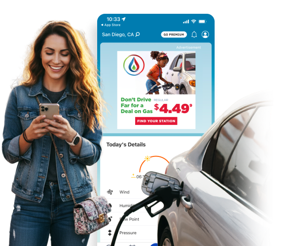 Woman at a gas station looking at her phone smiling at Swiftly offers.