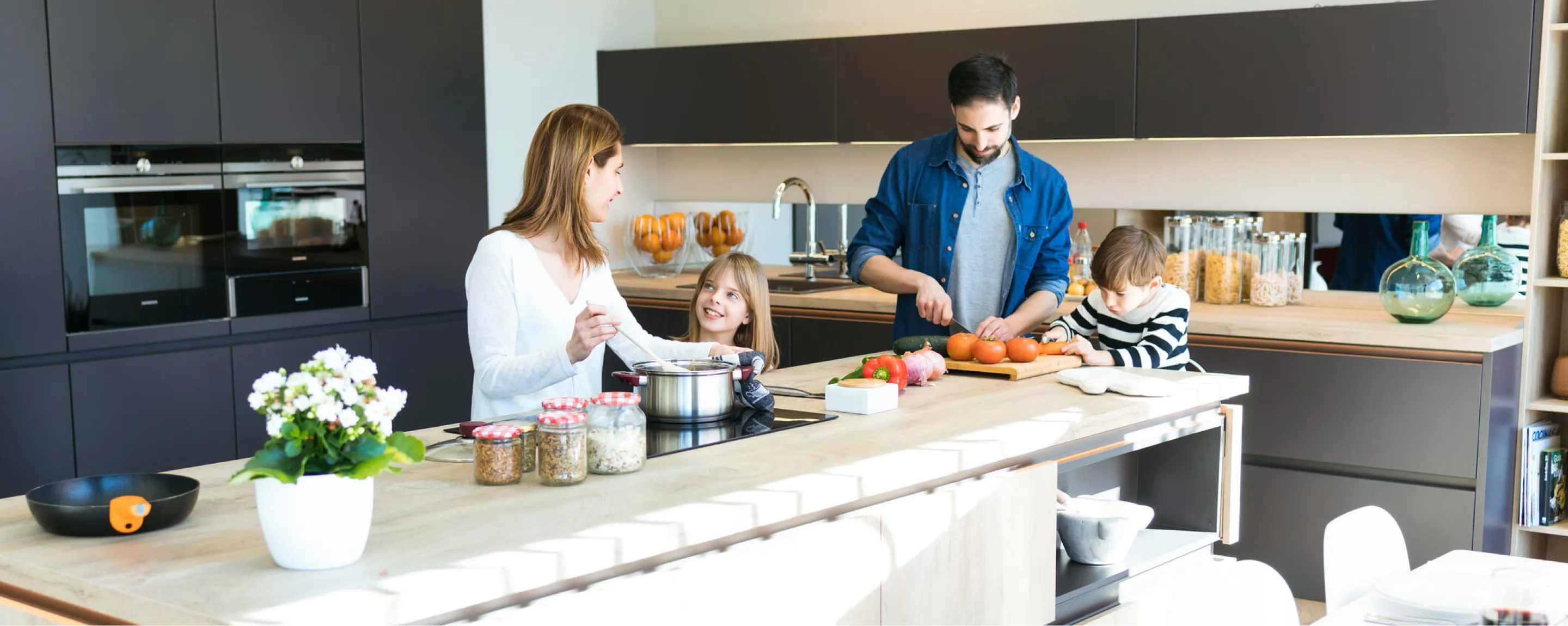 A family preparing food in the kitchen together.