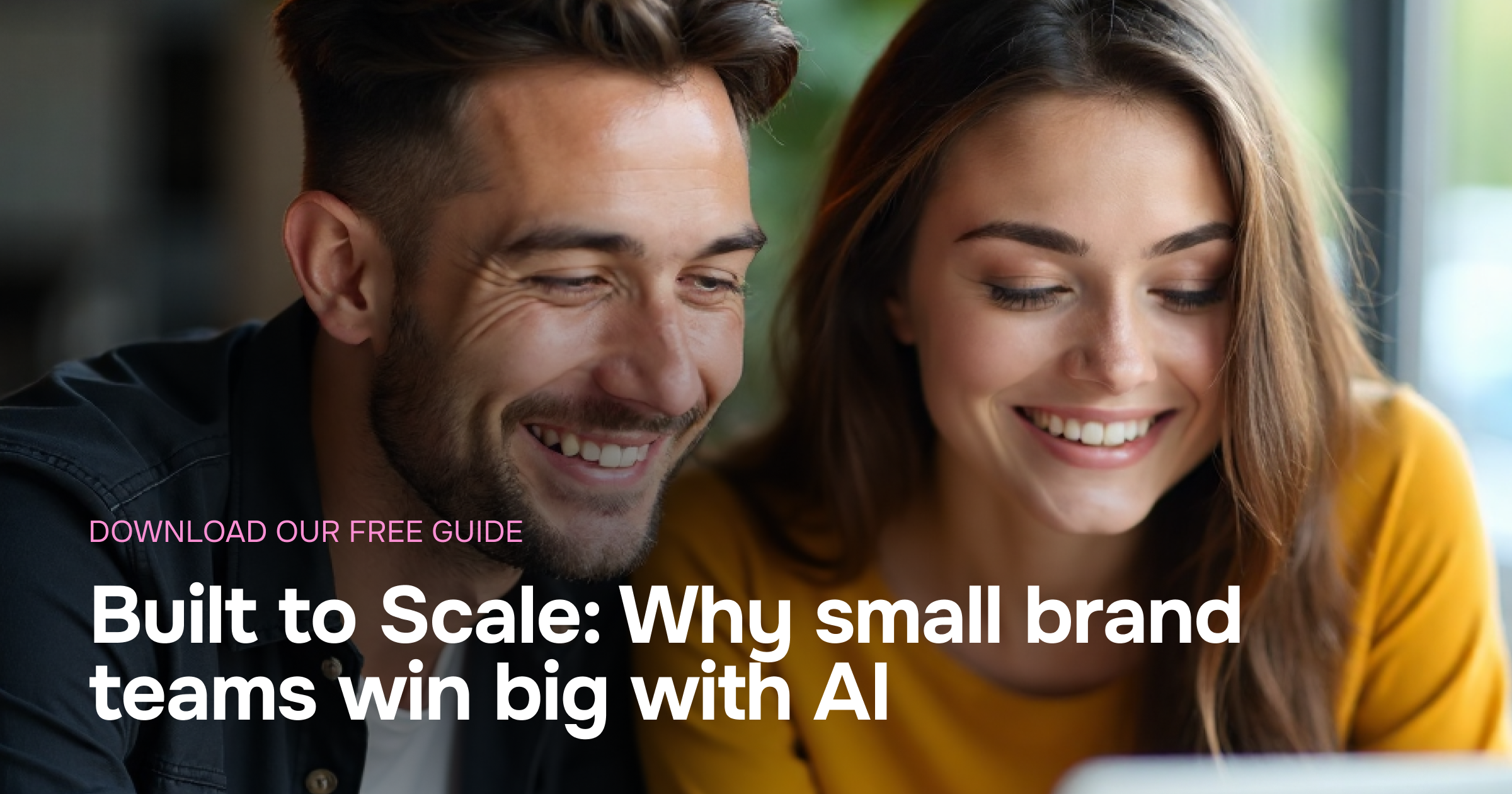 A man and a woman who are co-workers and young professionals are enthusiastically looking into a computer reviewing the marketing intelligence outputs from Mowie's Brand Dossier.