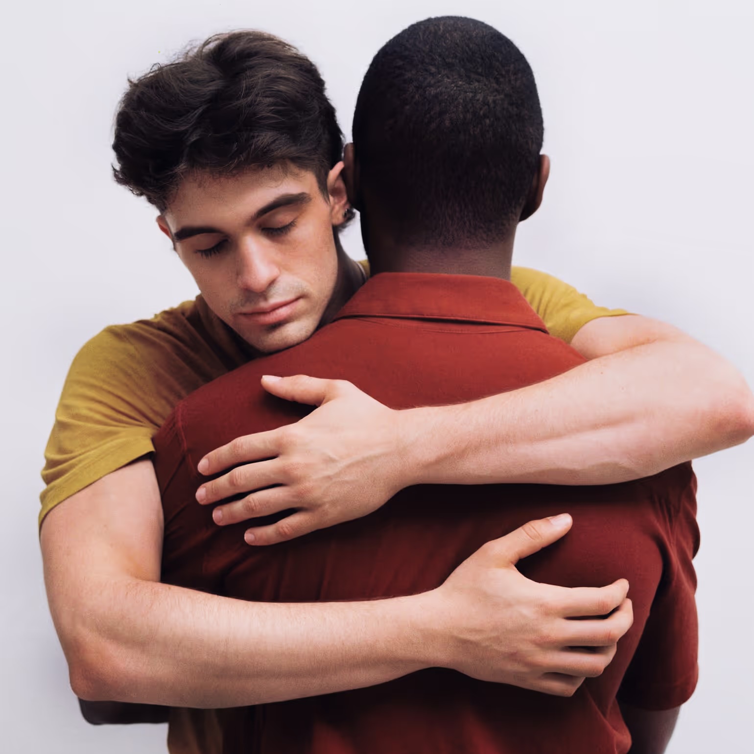 Two people embracing, wearing garments dyed with natural mango and mahogany.