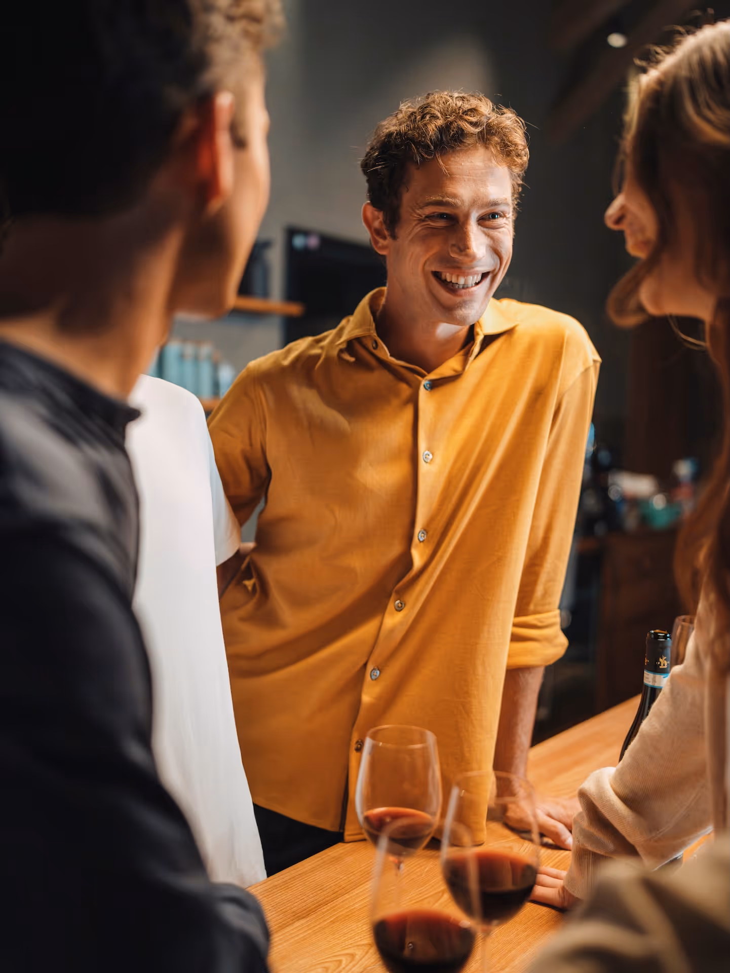 Group conversation with man in a mustard yellow Chirimoya Natural Dye Pima shirt.