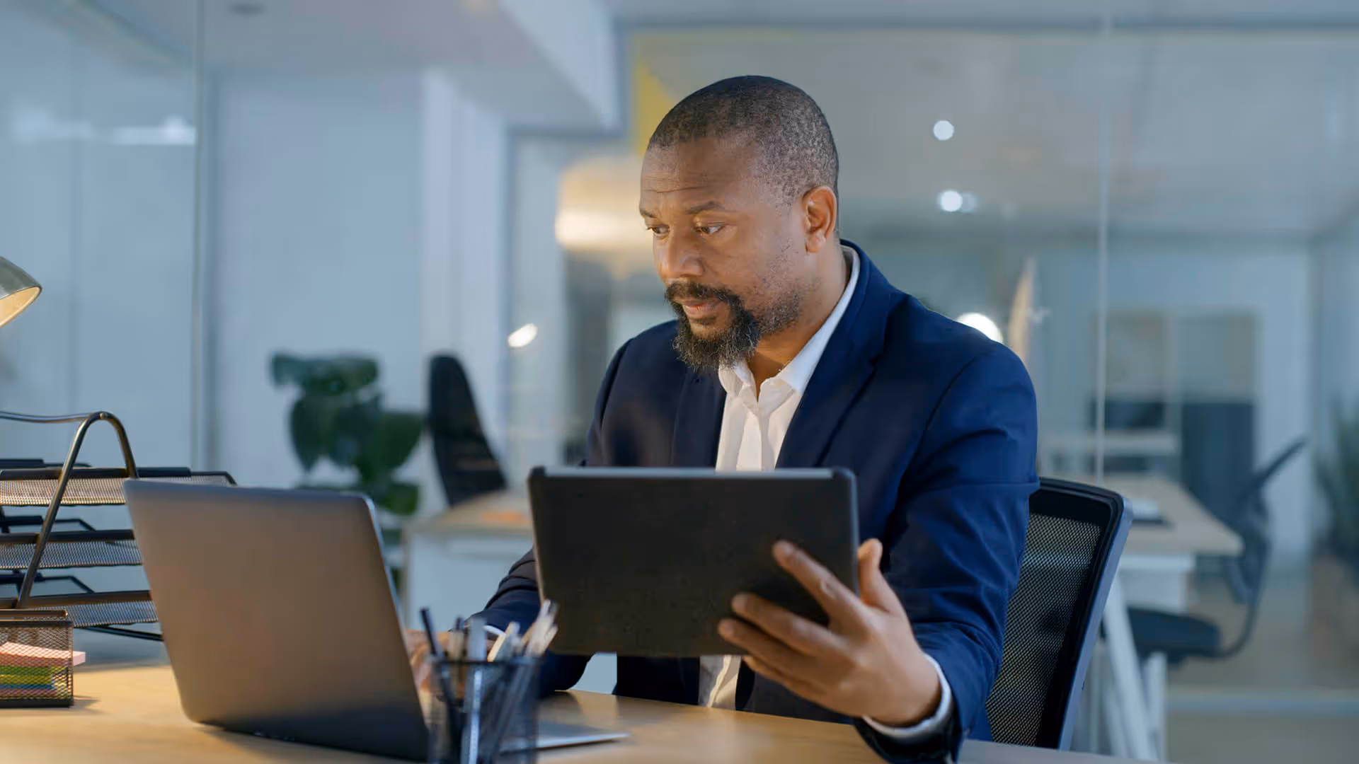Man looking at laptop and tablet devices