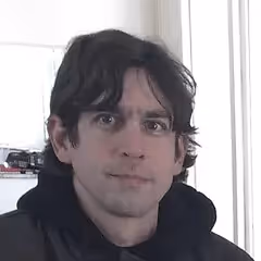 Professional headshot photo of Adolfo Neto, Associate Professor and podcast creator specializing in Elixir