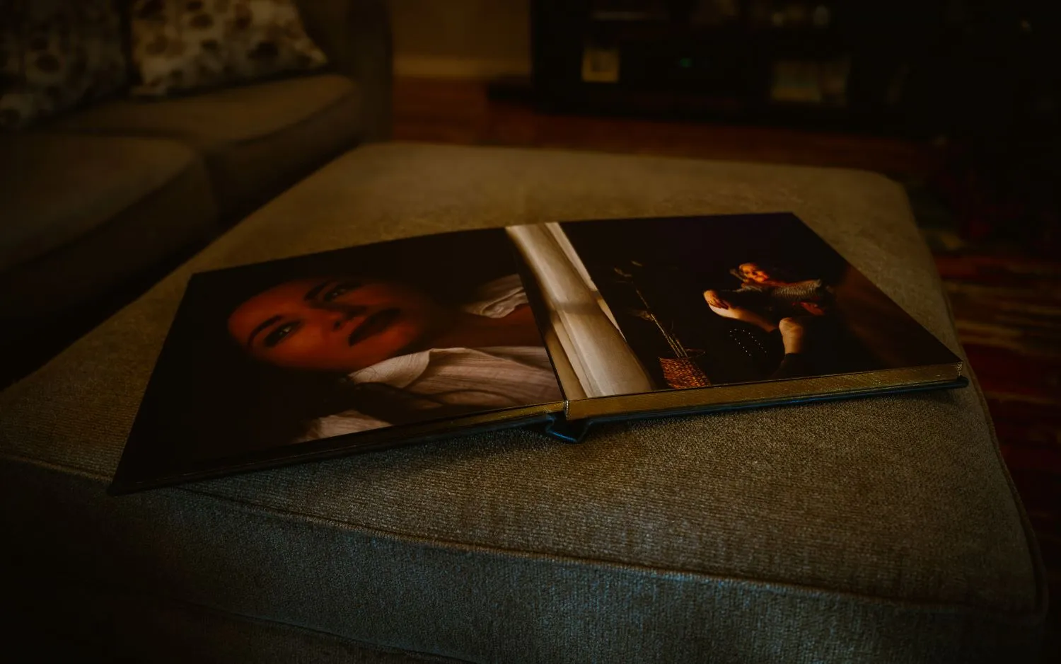 Steamy Esteem keepsake photo album displayed on ottoman. Full page photos of boudoir session. 
