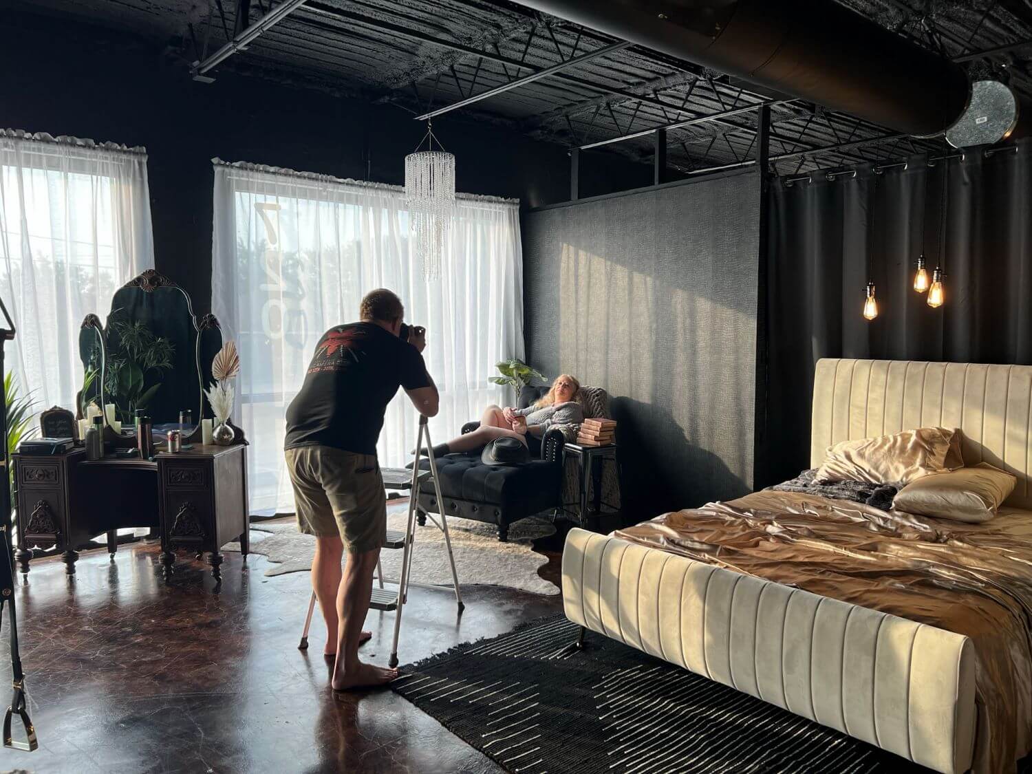 Allan Pickering of Steamy Esteem Boudoir photographing senior woman lounging on a chair in the studio. 