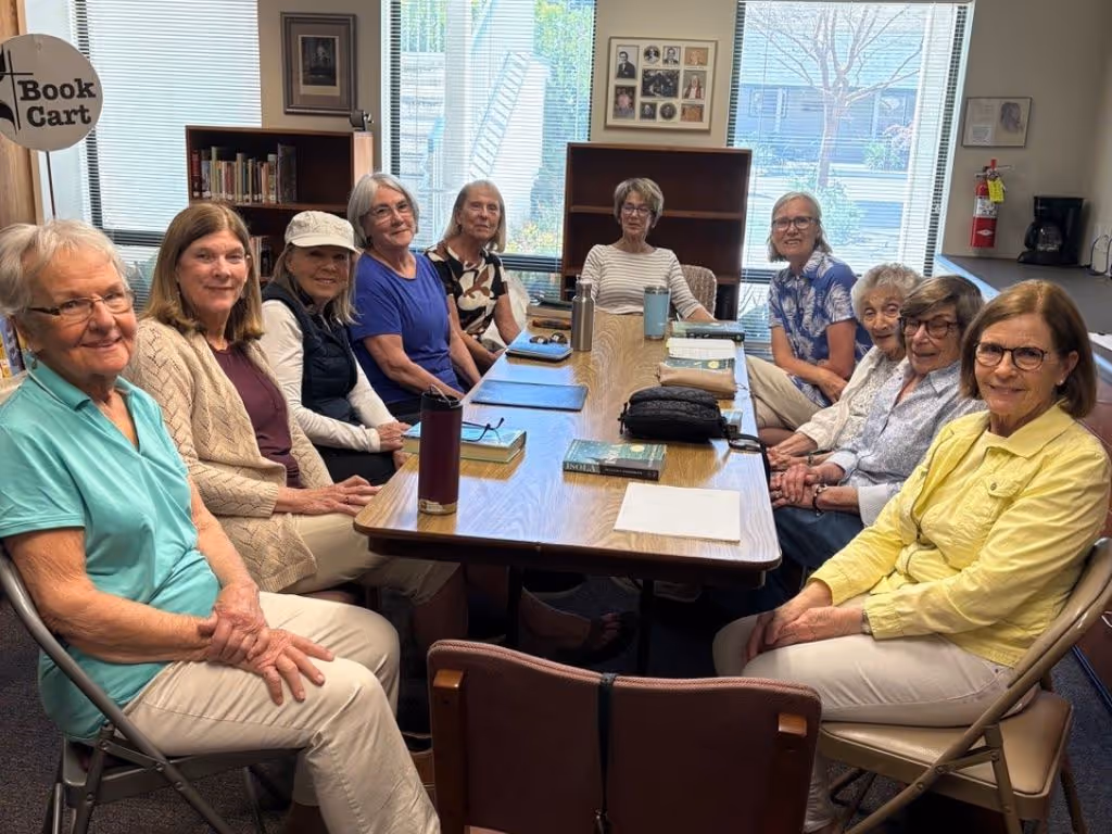 Two people walking through a peaceful forest.