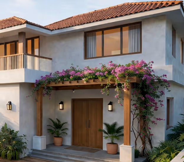 Discover Svasa by Nurall, luxury wellness villa with a two-story house entrance with wooden double doors, a wooden pergola adorned with pink flowering vines, and potted plants on either side.
