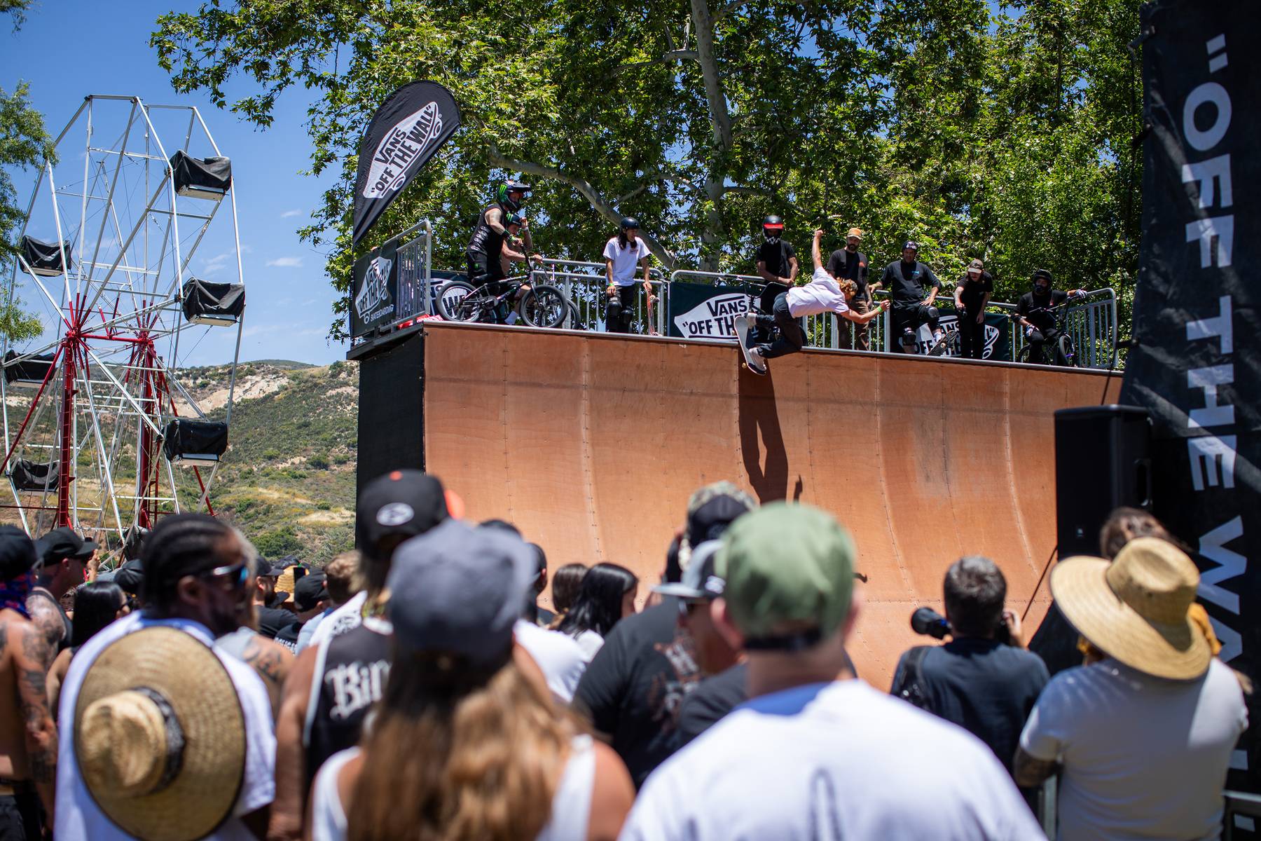Skateboarder doing trick on half pipe