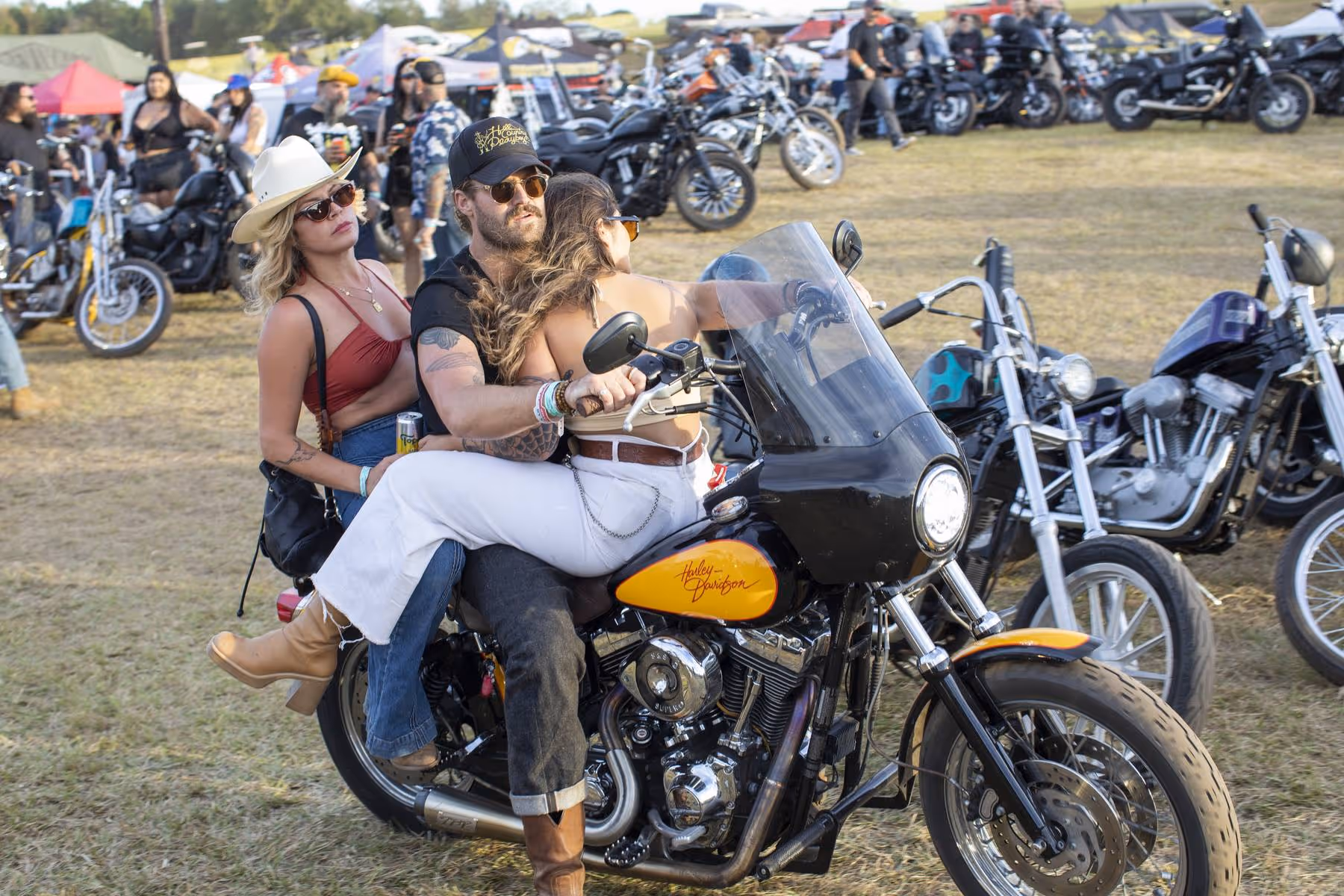 Man riding motorcycle with two women