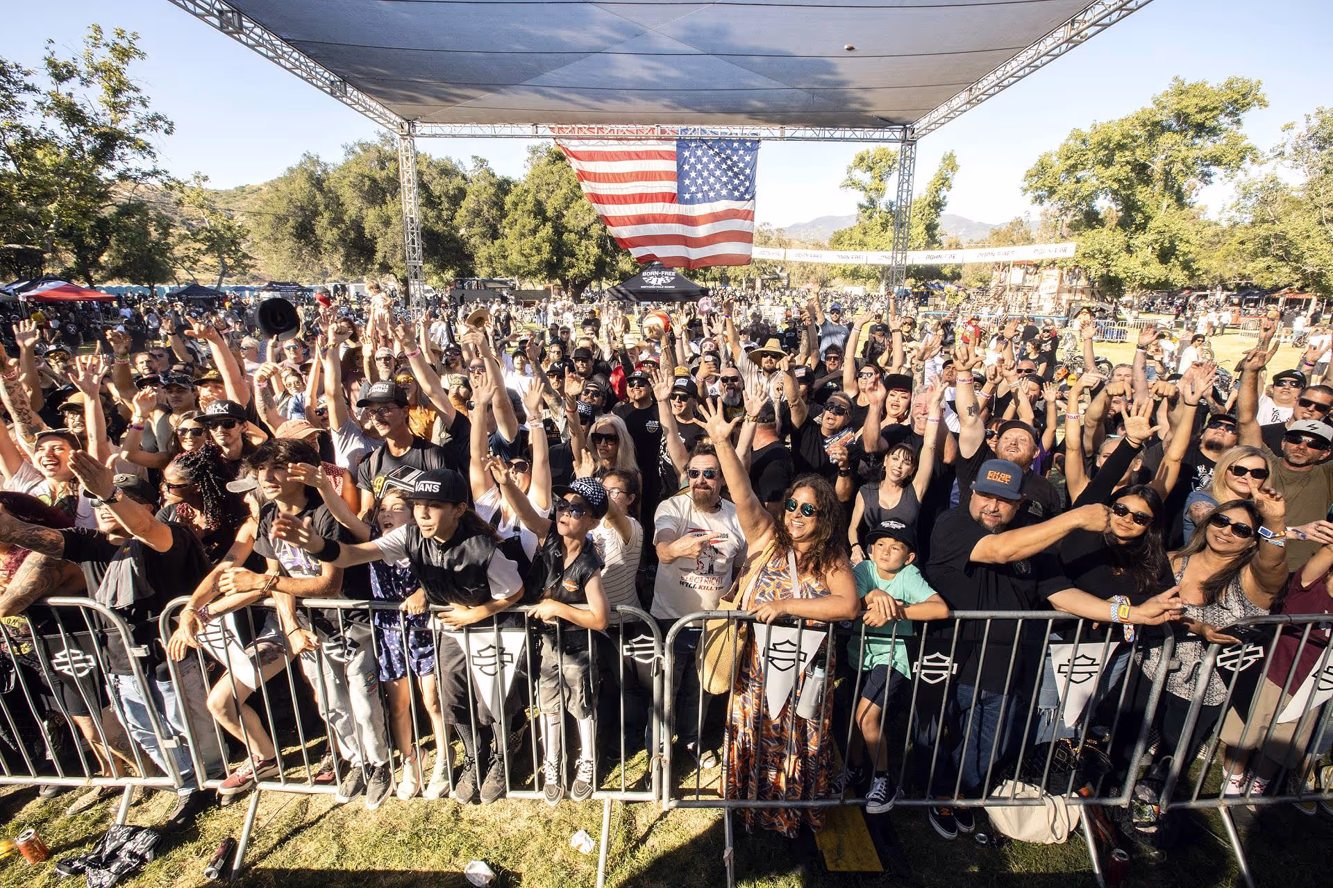 A large crowd cheering while watching a performance