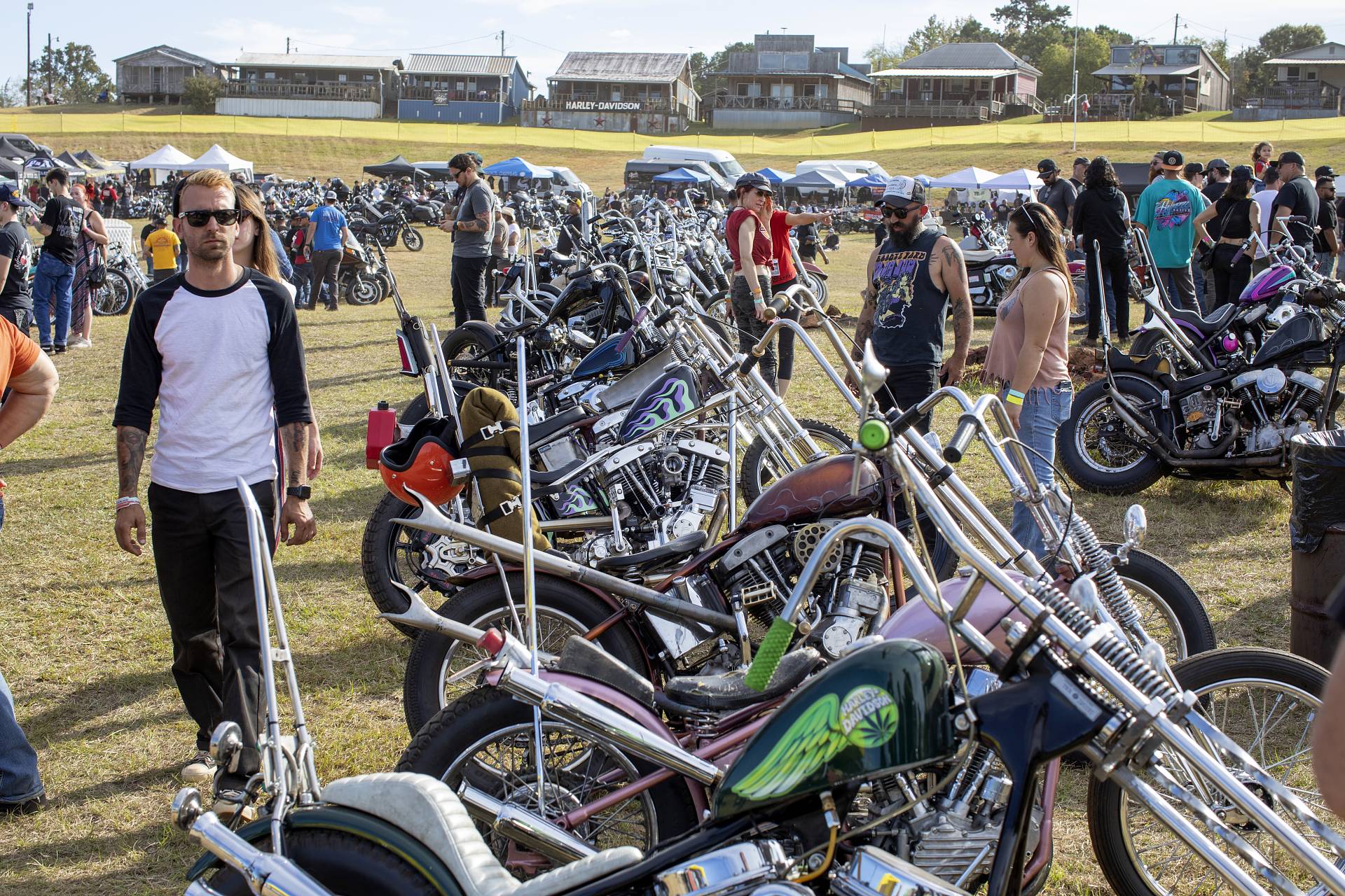 Show attendees admiring motorcycles on display
