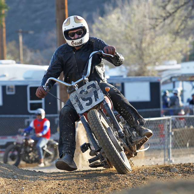 Rider turning sharp on dirt