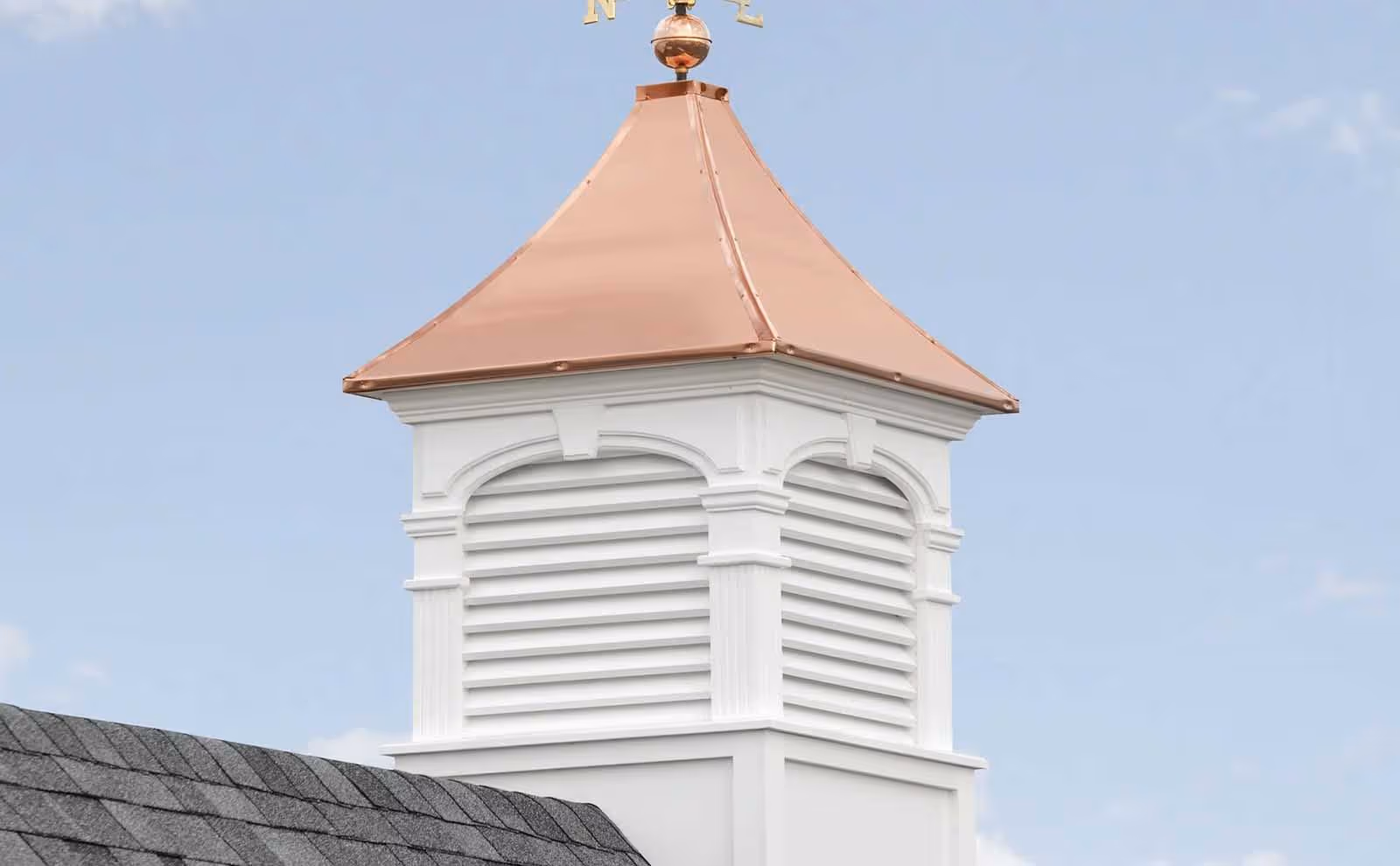 Signature Alexander cupola with arched white louvers and a copper roof, offering a stately finish to garages, barns, and rooftops in Millersburg, OH.
