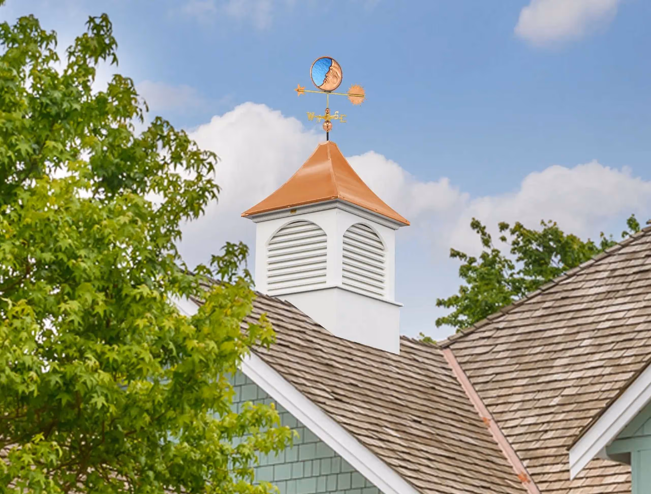 Danbury signature cupola featuring white arched louvers, detailed trim, and a brilliant copper spire, crafted in Millersburg, Ohio.