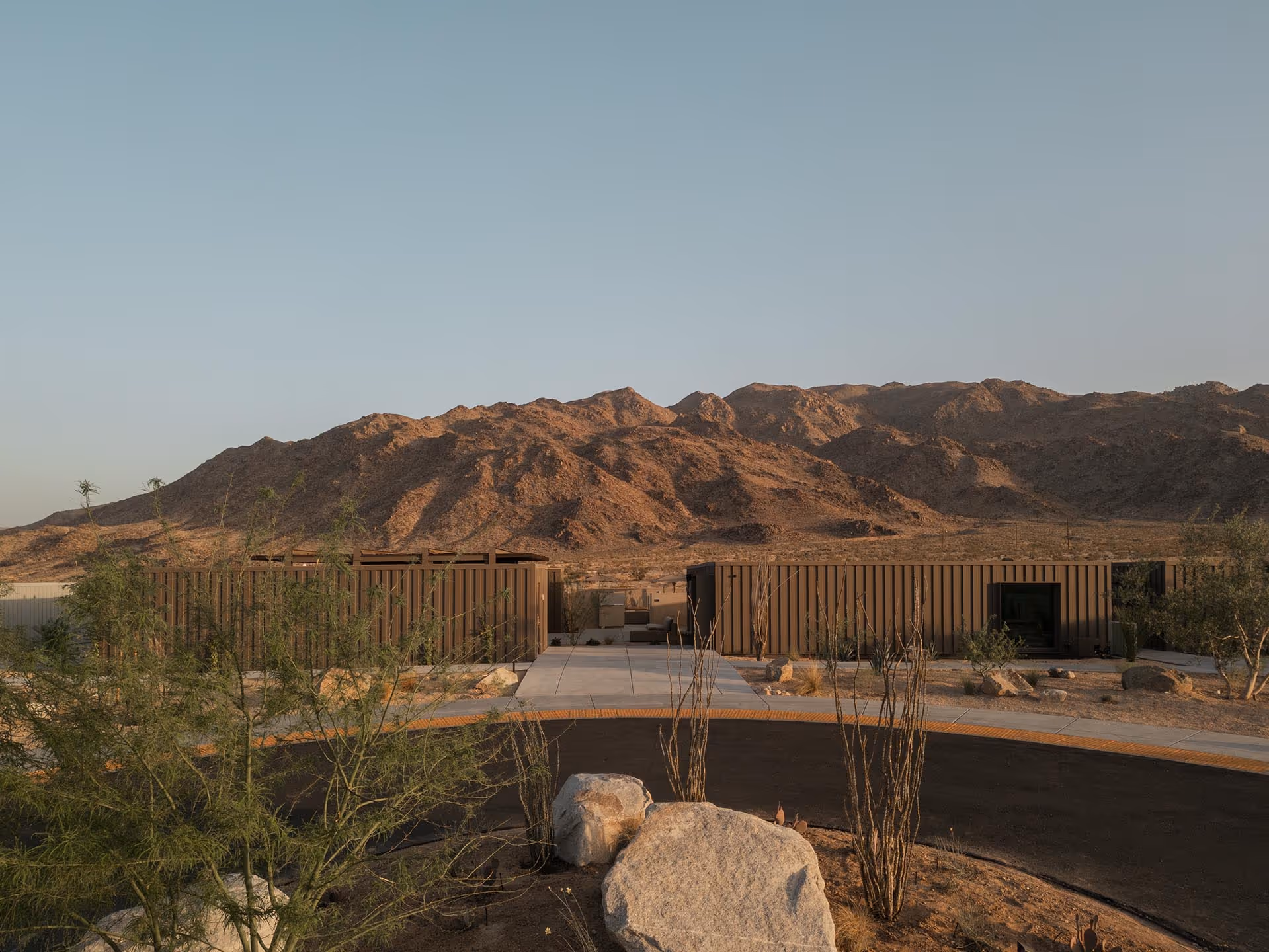 Reset Hotel rooms exterior in Twentynine Palms, a modern wood-clad desert stay with mountains