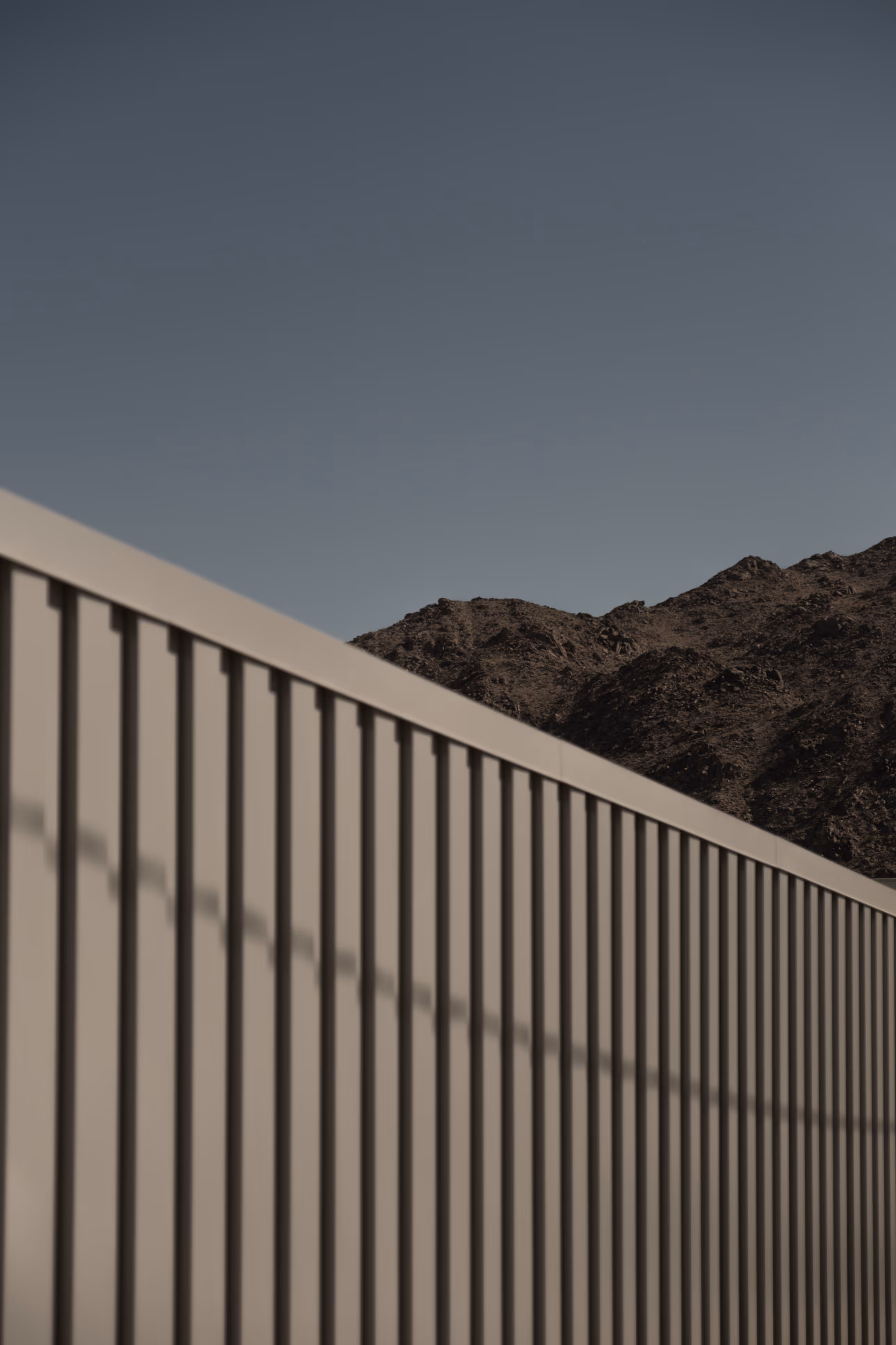 Textured fence and mountain landscape outside Reset Hotel stays in Twentynine Palms