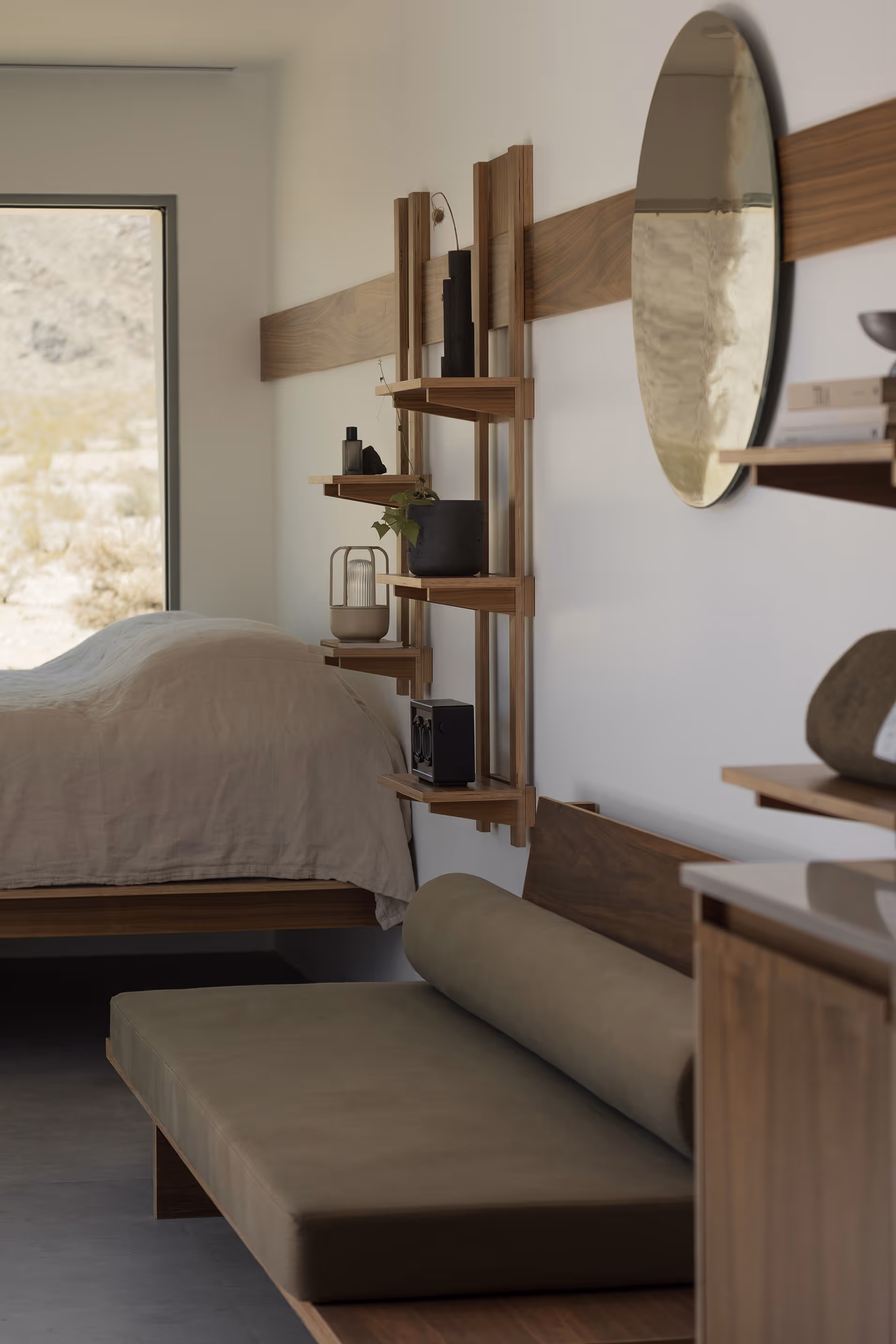 Modern minimalist bedroom at Reset Hotel, Twentynine Palms, with natural materials and chaise lounge