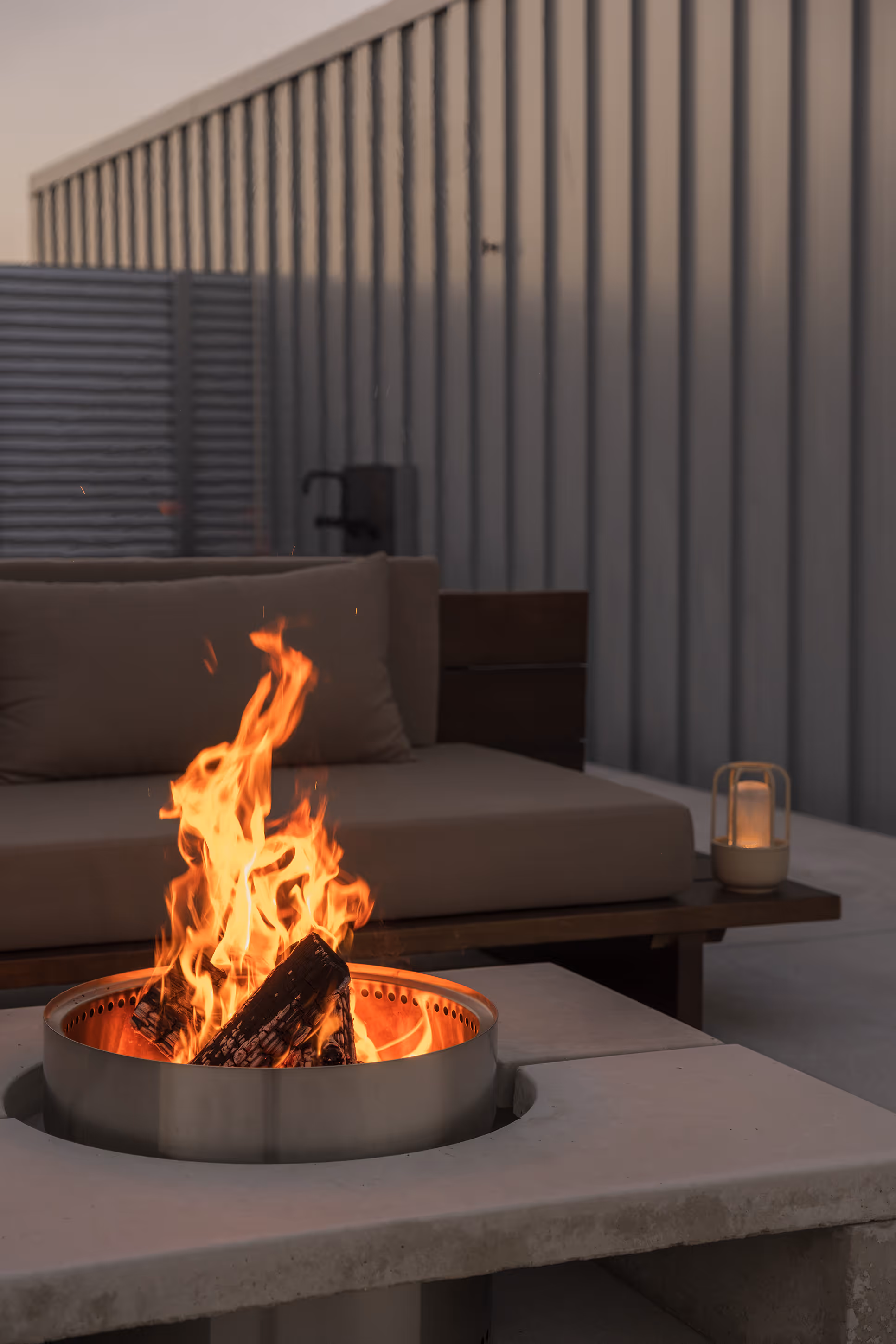 Fire pit and lantern at Reset Hotel’s Twentynine Palms lounge, perfect for relaxing evenings