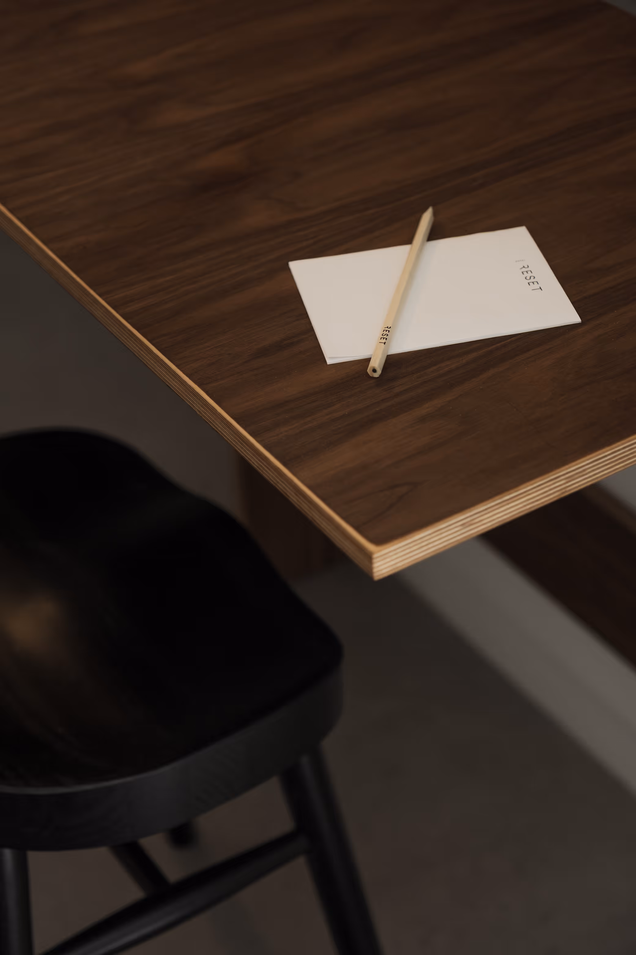 Wooden table at Reset Hotel with “RESET” note and pencil, Twentynine Palms CA