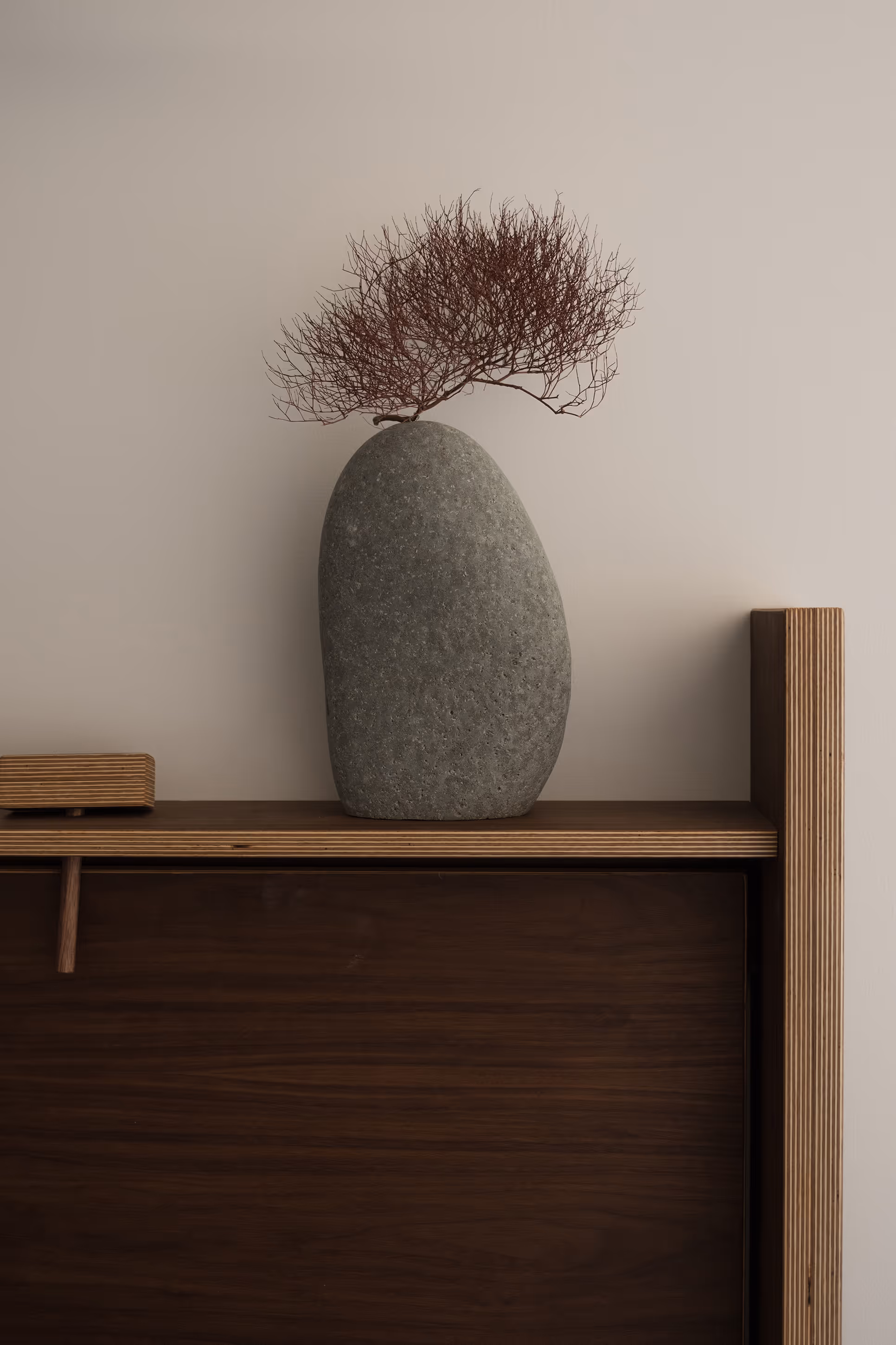 Decorative gray stone and dried branches on wooden shelf in Reset Hotel room, Twentynine Palms