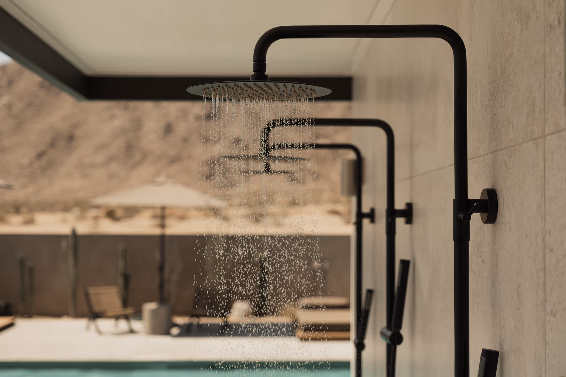 Black outdoor shower at Reset Hotel with desert view and pool in Twentynine Palms