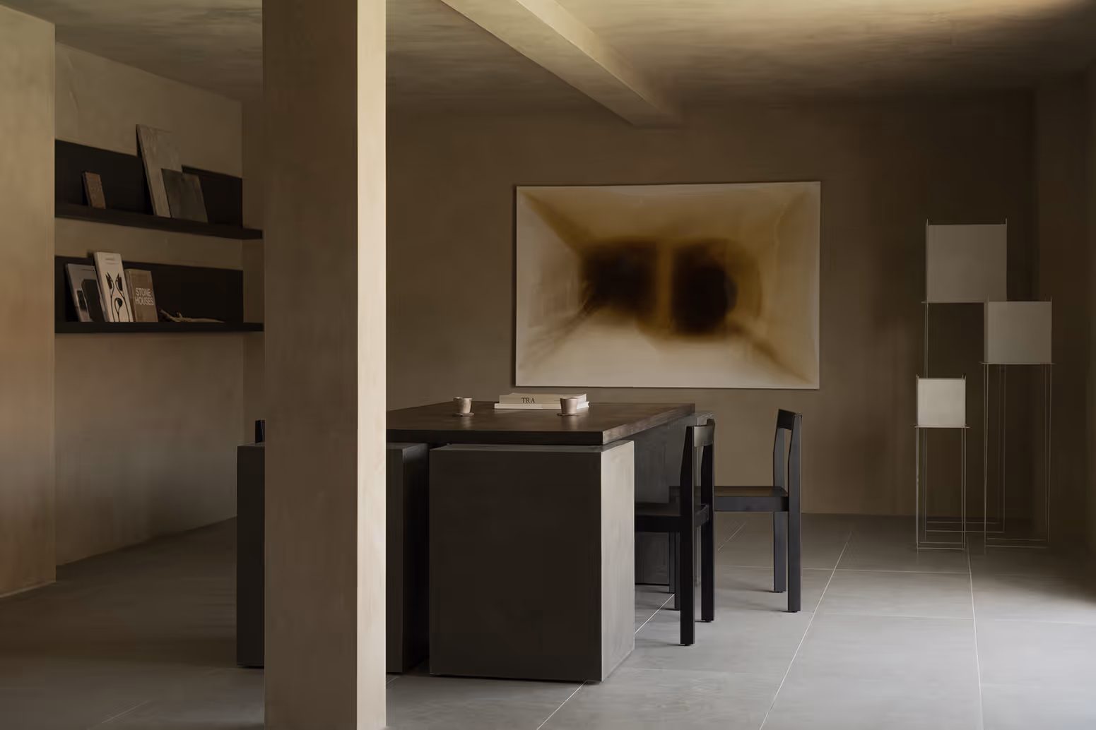 Reset Hotel dining area in Twentynine Palms featuring concrete table, chairs, and abstract art