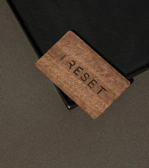 Reset Hotel wooden keycard on dark tray in Twentynine Palms, California
