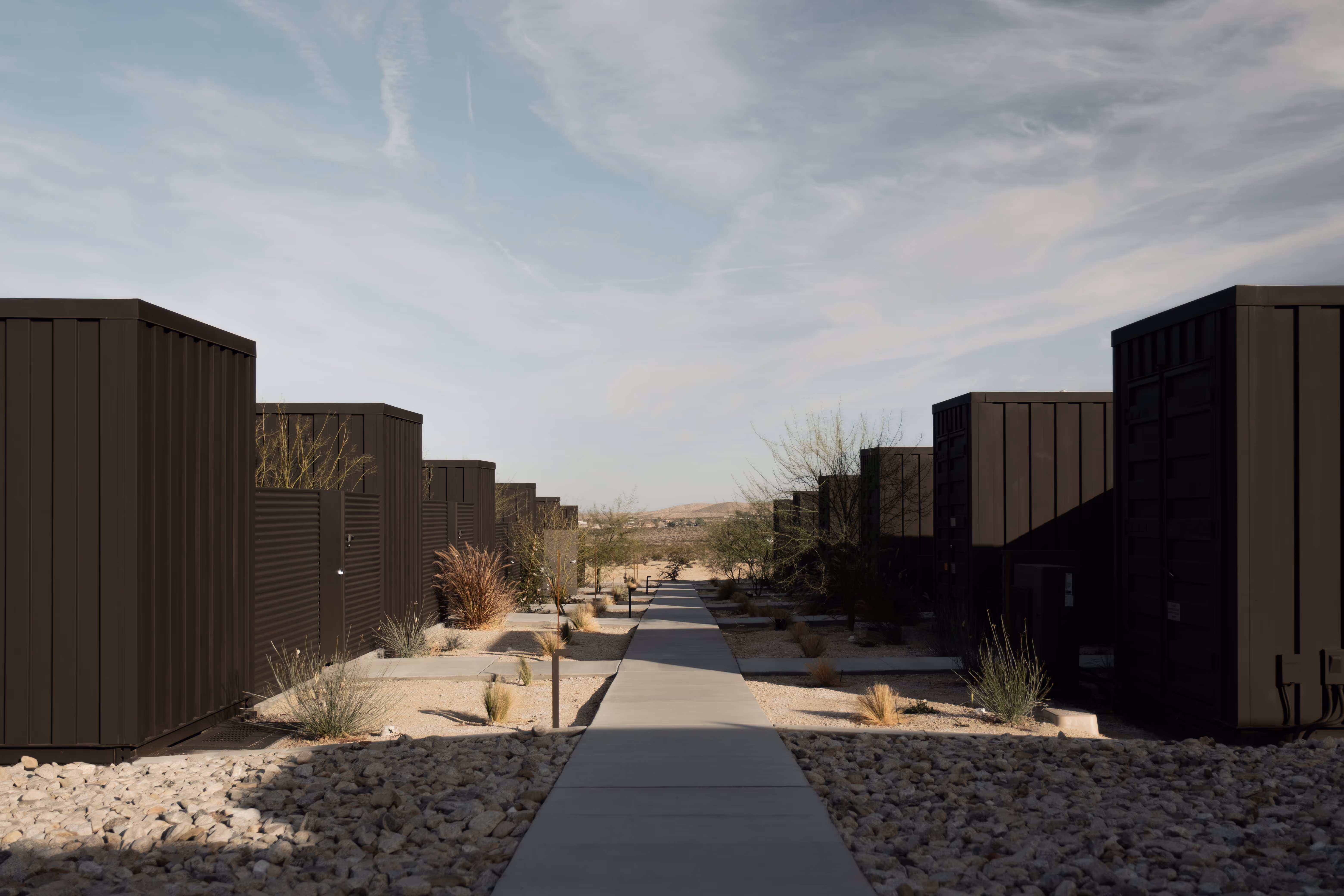 Reset Hotel rooms exterior in Twentynine Palms, a modern wood-clad desert stay with mountains