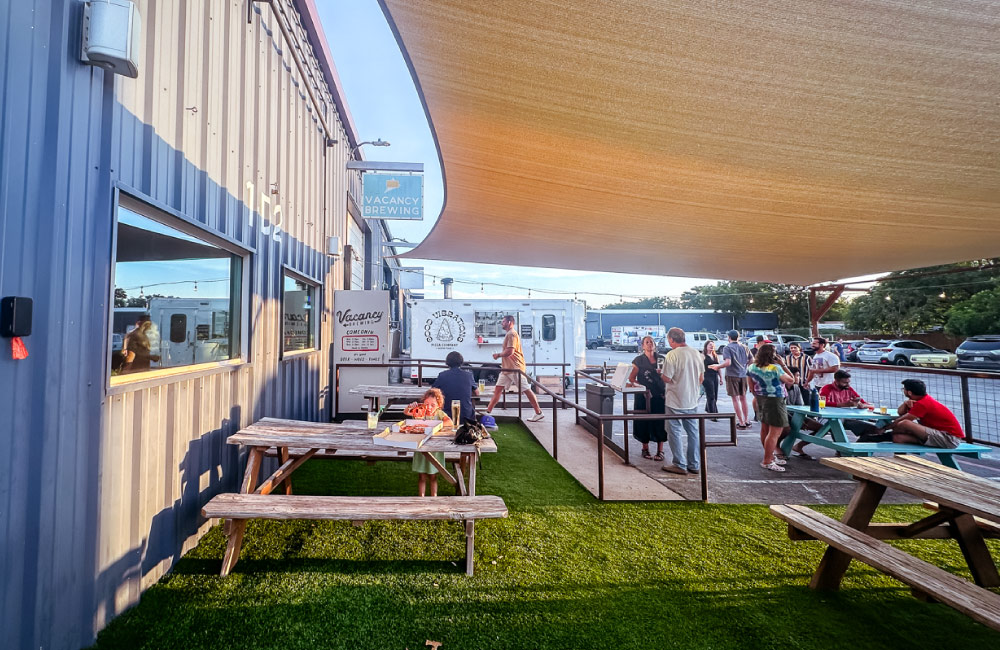 Vacancy Brewing Shaded Patio with pet friendly area and pizza