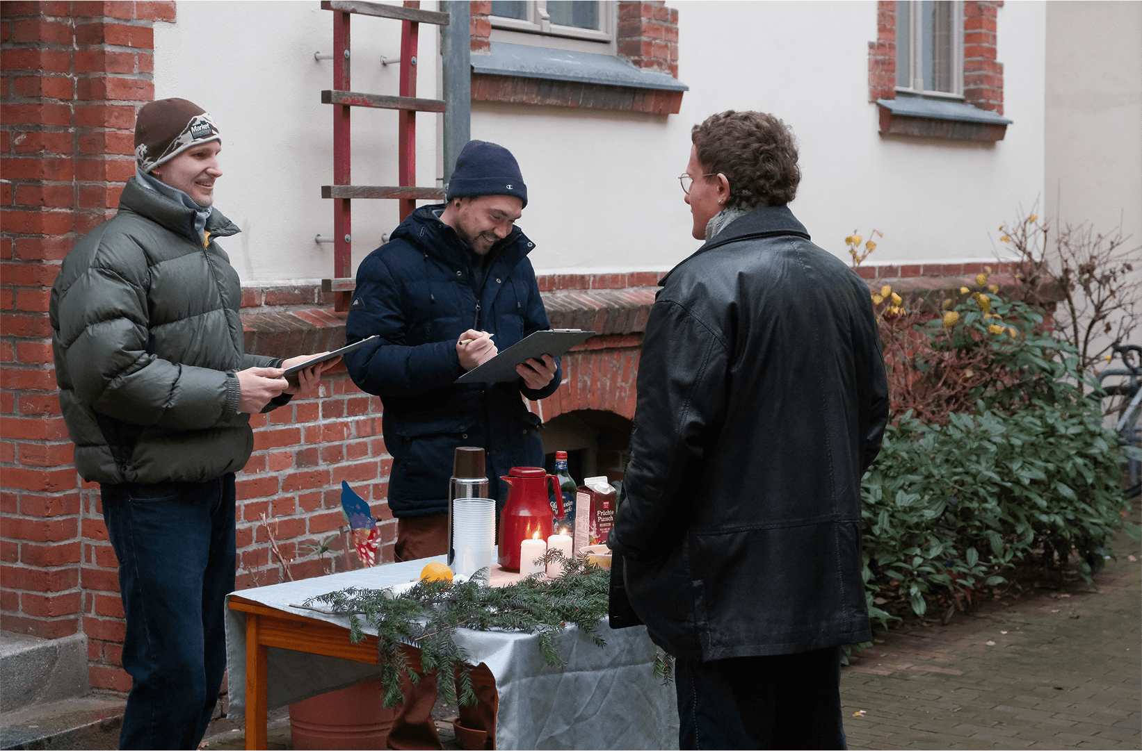 Me and Kilian interviewing a citizen in front of a small decorated table