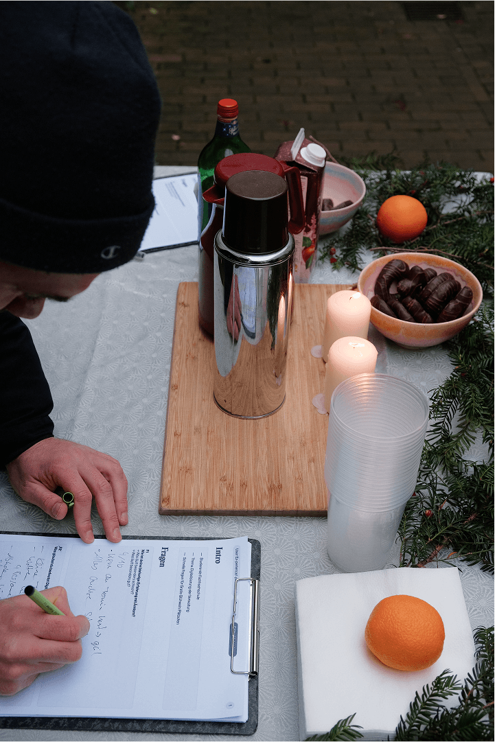 Close up of Kilian writing notes on a clipboard