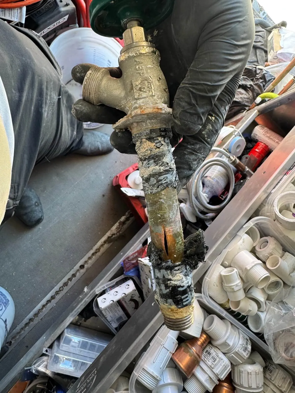 Leaking hose bib with a burst copper flange from leaving a hose connected during a deep freeze