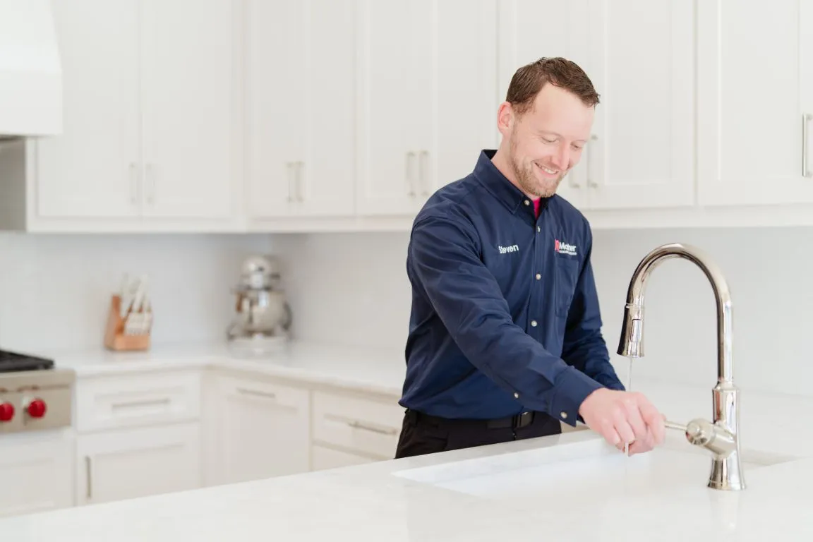 A plumber from Mother Modern Plumbing performing Faucet Installation in Arlington
