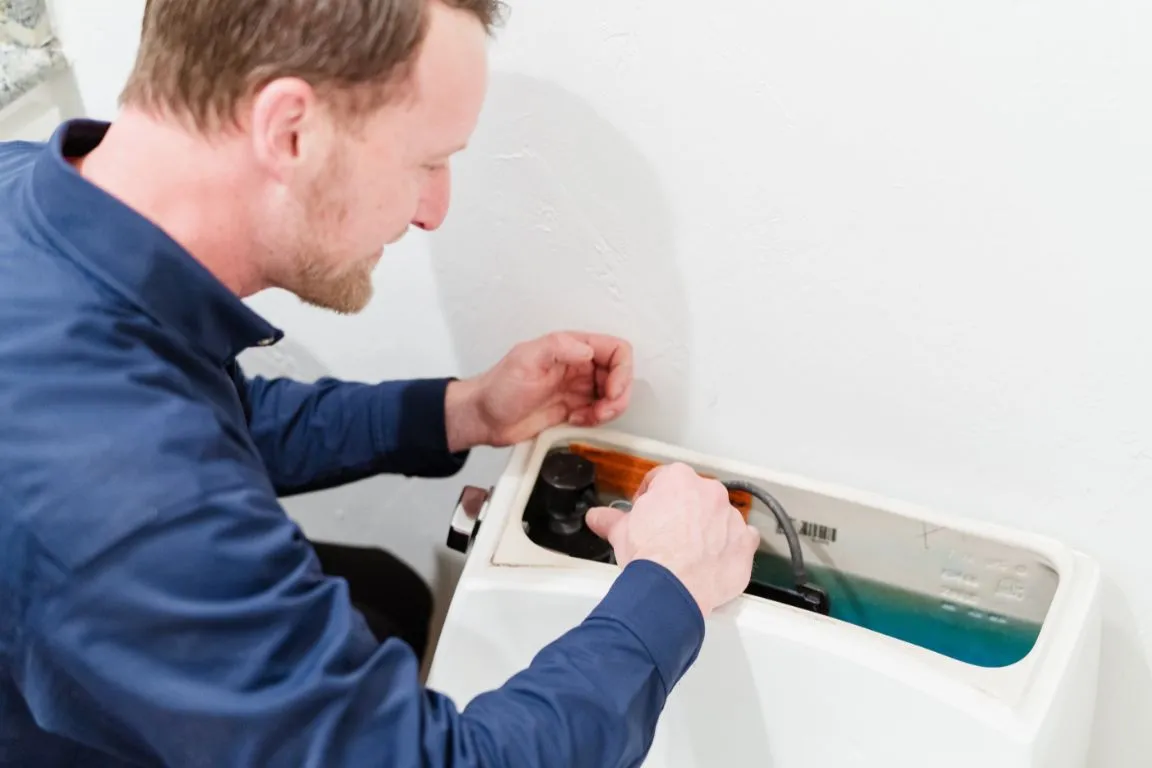 A plumber from Mother Modern Plumbing performing Toilet Repair and Rebuild in Rowlett