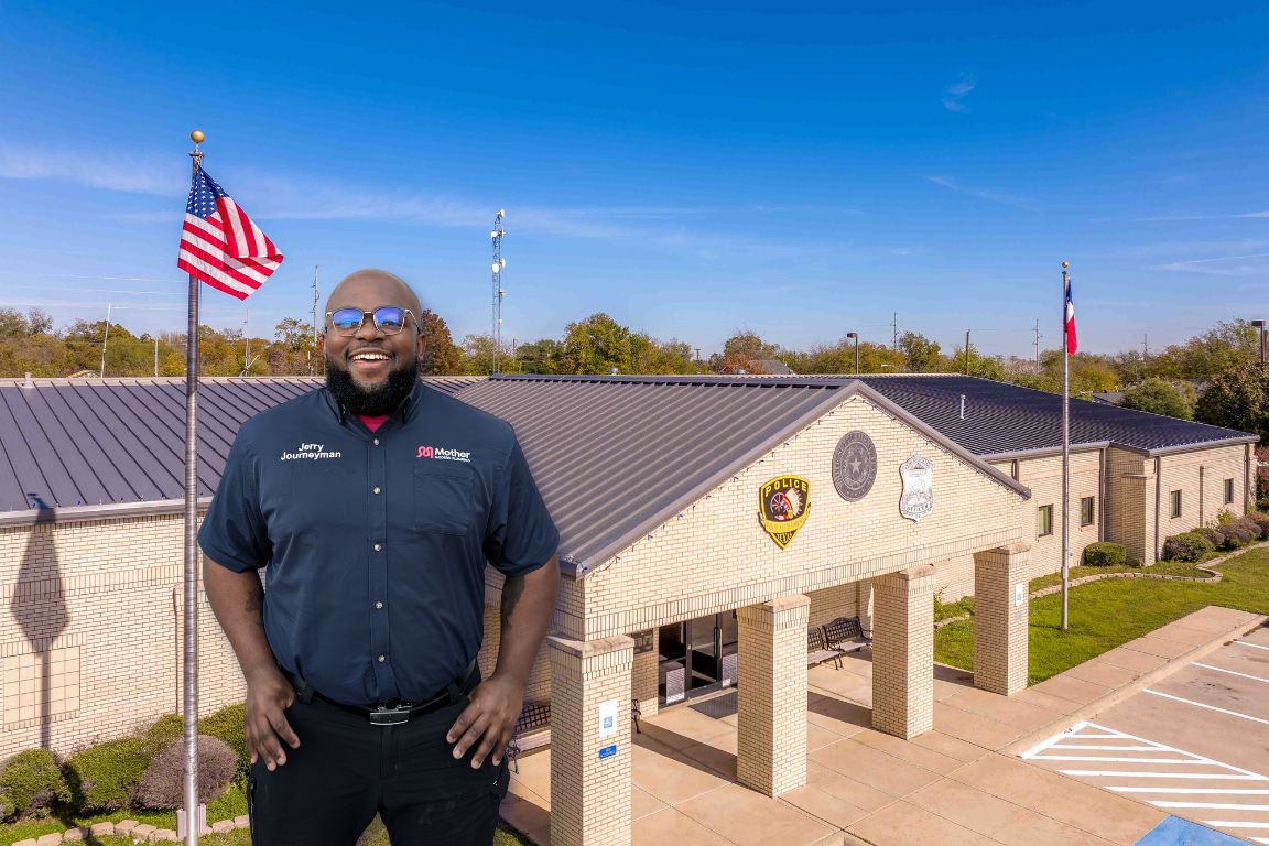 Photo of a uniformed plumber in White Settlement, TX from Mother Modern Plumbing standing and smiling