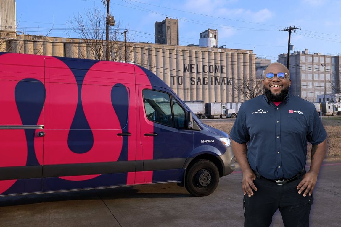 Photo of a uniformed plumber in Saginaw, TX from Mother Modern Plumbing standing and smiling