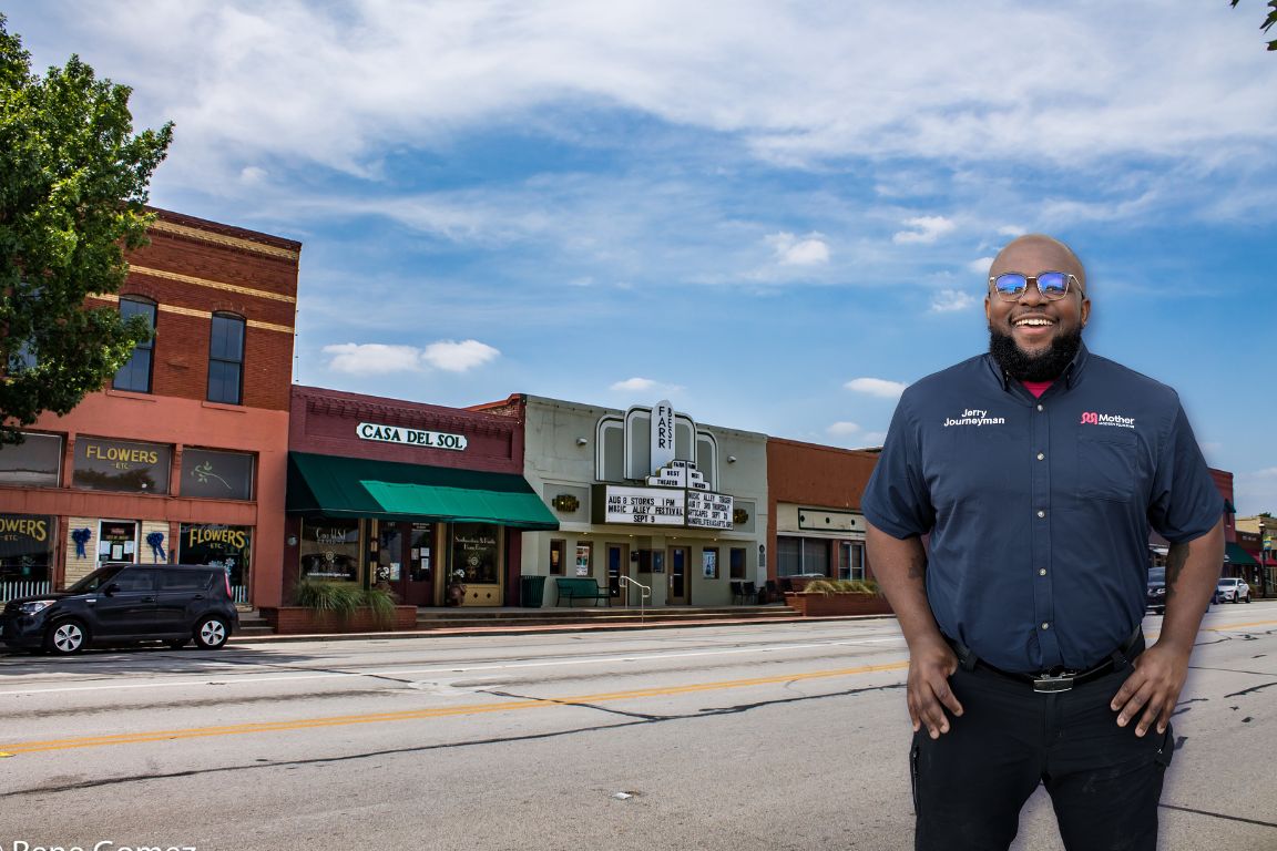 Photo of a uniformed plumber in Mansfield, TX from Mother Modern Plumbing standing and smiling