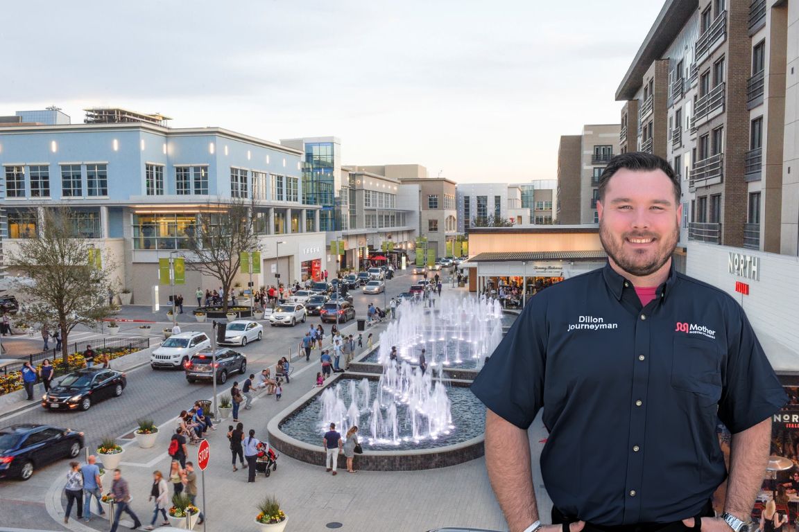 Photo of a uniformed plumber in Plano, TX from Mother Modern Plumbing standing and smiling