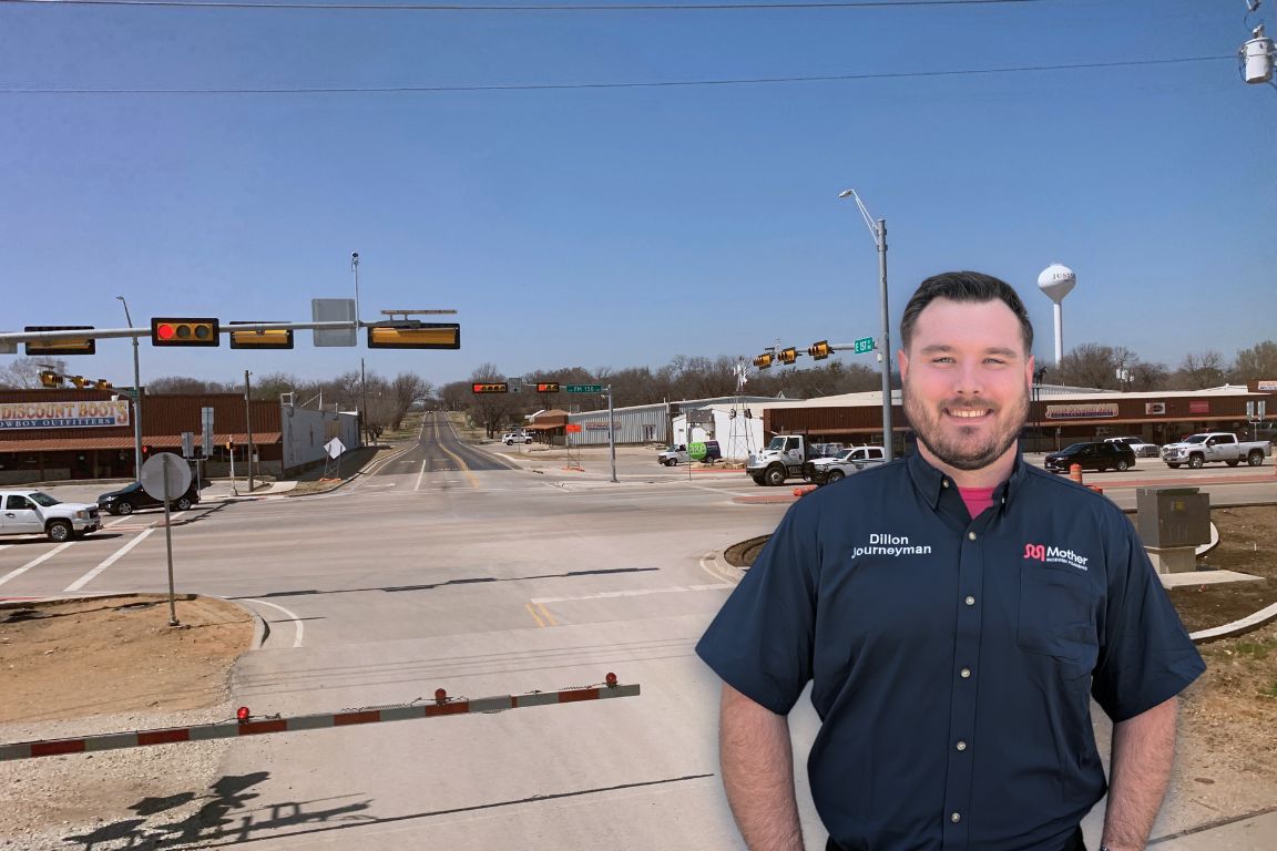 Photo of a uniformed plumber in Justin, TX from Mother Modern Plumbing standing and smiling