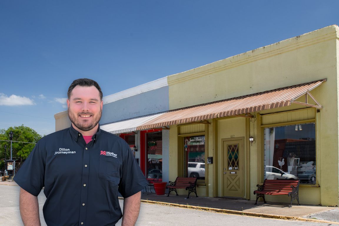 Photo of a uniformed plumber in Cedar Hill, TX from Mother Modern Plumbing standing and smiling