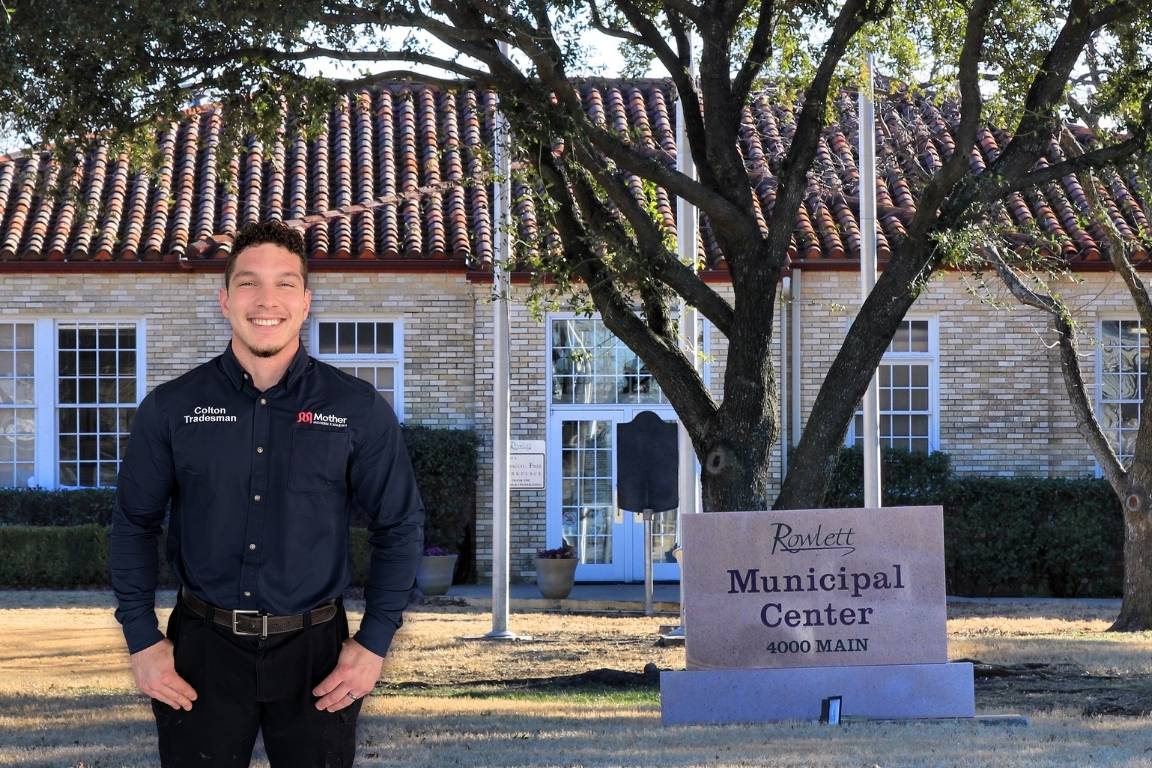 Photo of a uniformed plumber in Rowlett, TX from Mother Modern Plumbing standing and smiling