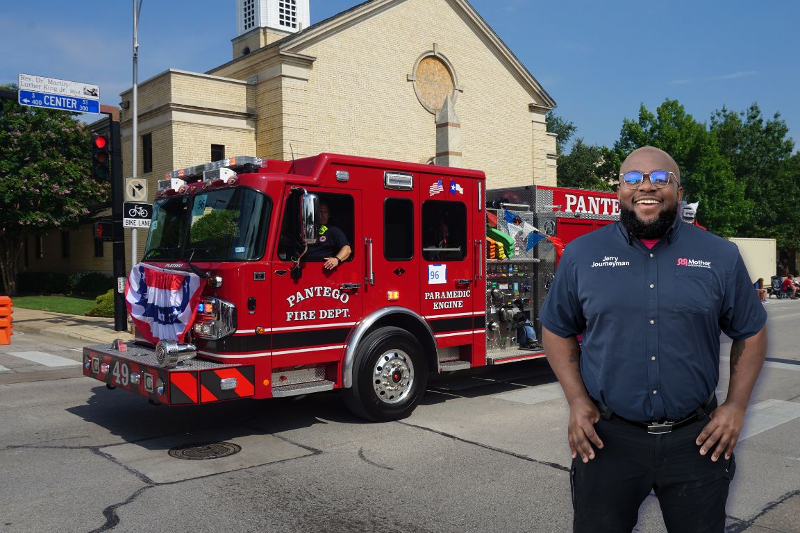Photo of a uniformed plumber in Pantego, TX from Mother Modern Plumbing standing and smiling