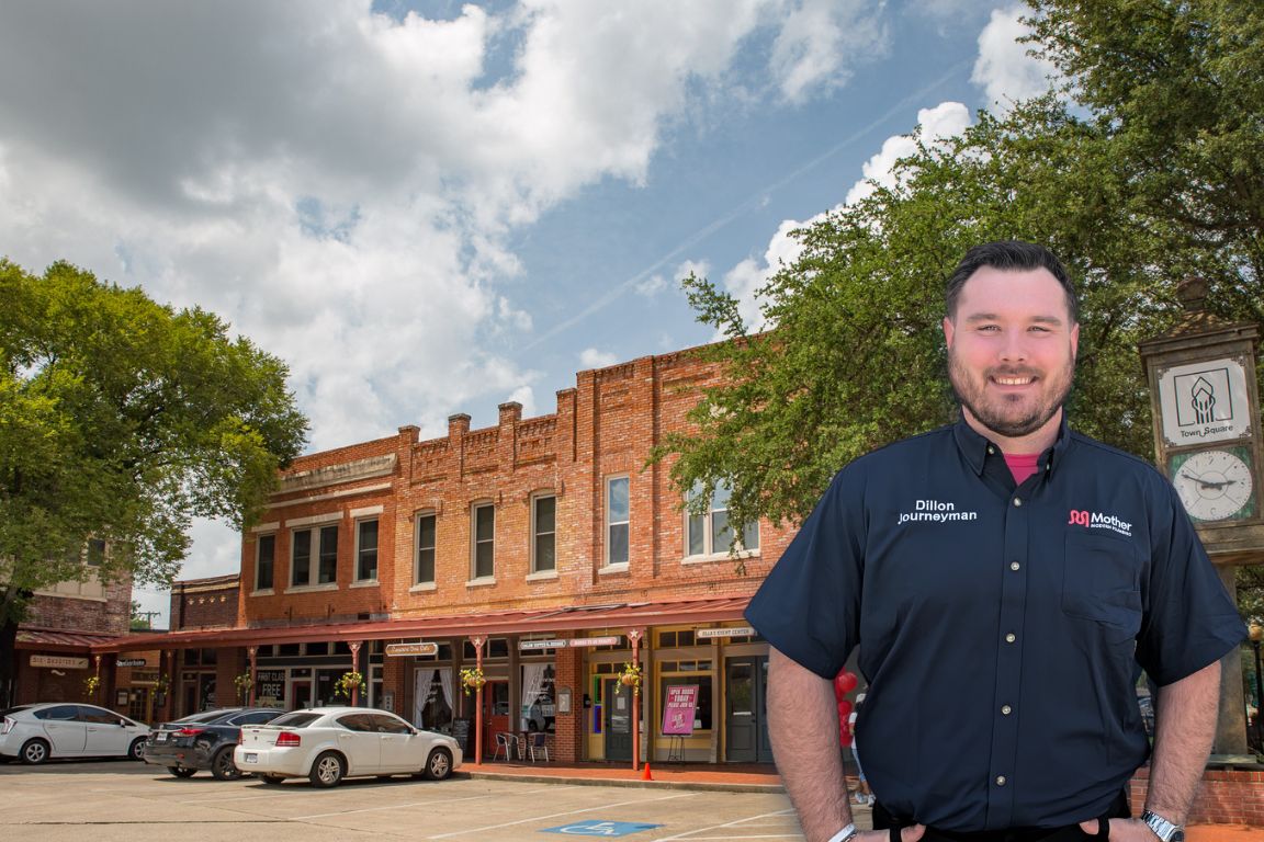 Photo of a uniformed plumber in Lancaster, TX from Mother Modern Plumbing standing and smiling