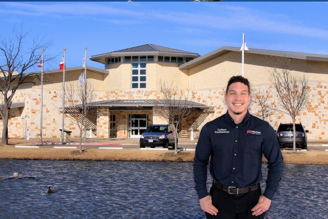 Photo of a uniformed plumber in Sachse, TX from Mother Modern Plumbing standing and smiling